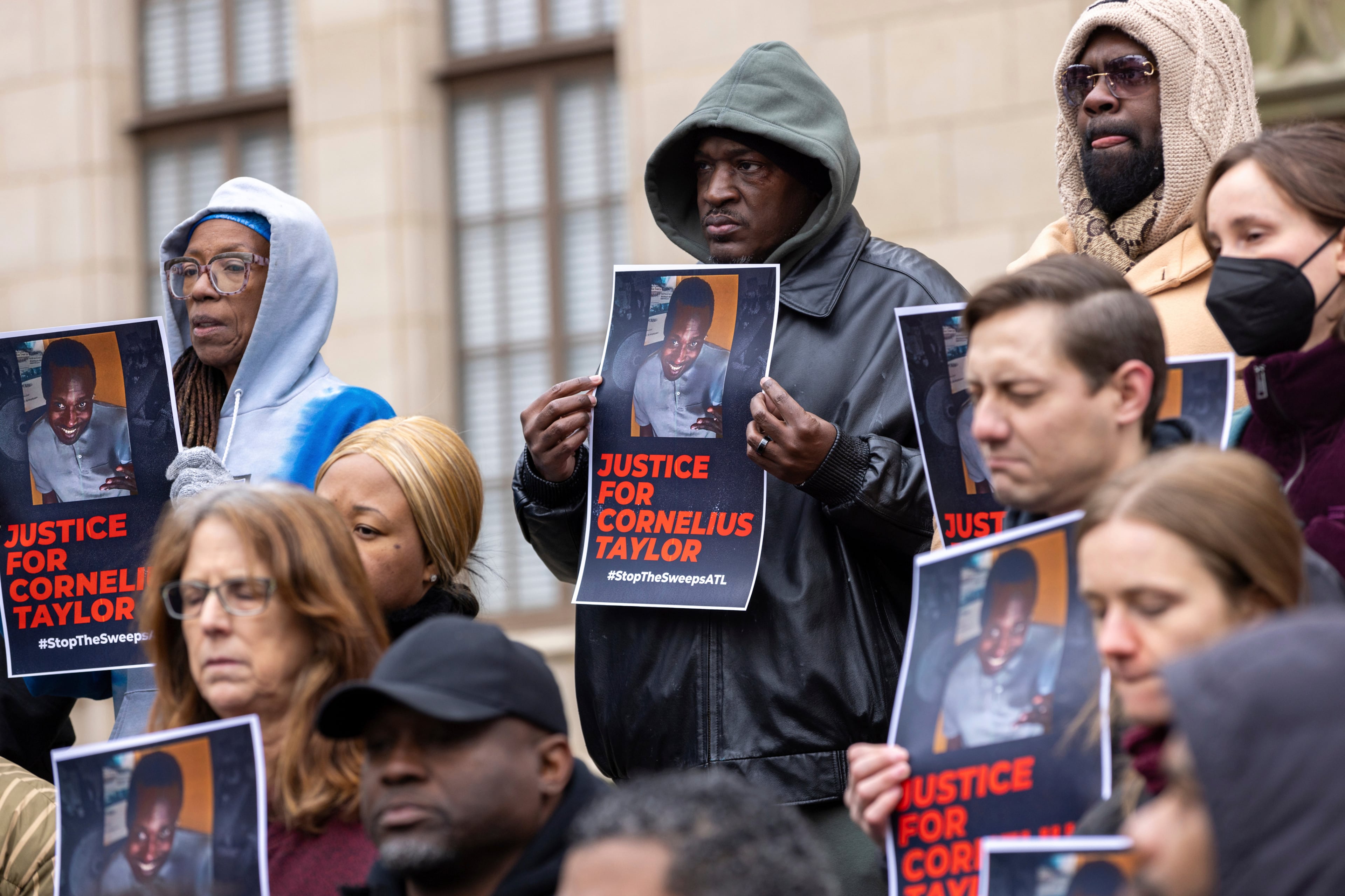 Family members and supporters protest in front of Atlanta City Hall on Jan. 23, 2025, days after the death of Cornelius Taylor, an unhoused man killed when the city cleared an encampment of unhoused people. (Arvin Temkar/AJC file)