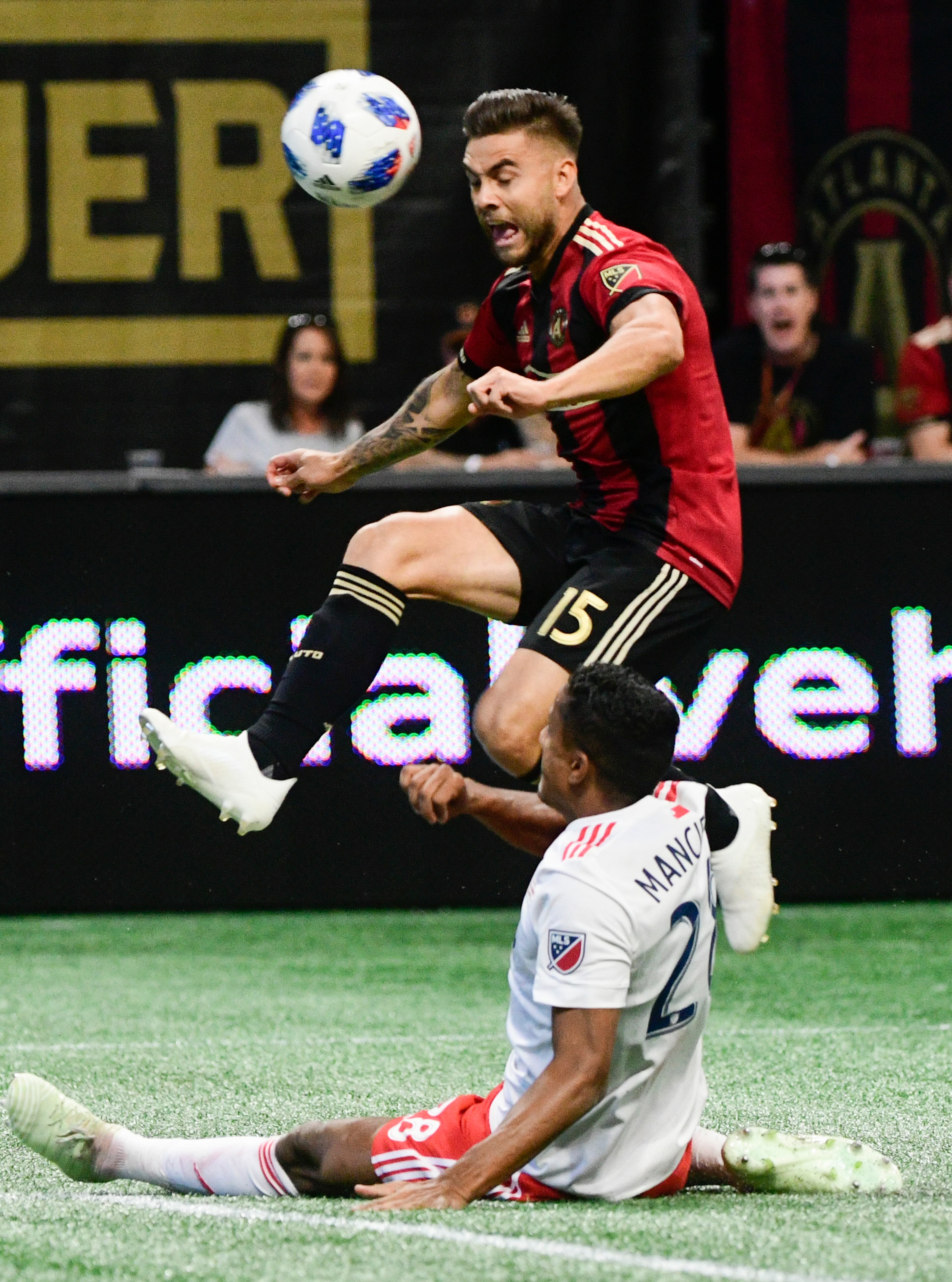 Atlanta United forward Hector Villalba (15) is challenged for the ball by New England Revolution's Michael Mancienne during the first half of an MLS soccer game, Saturday, Oct. 6, 2018. (John Amis)