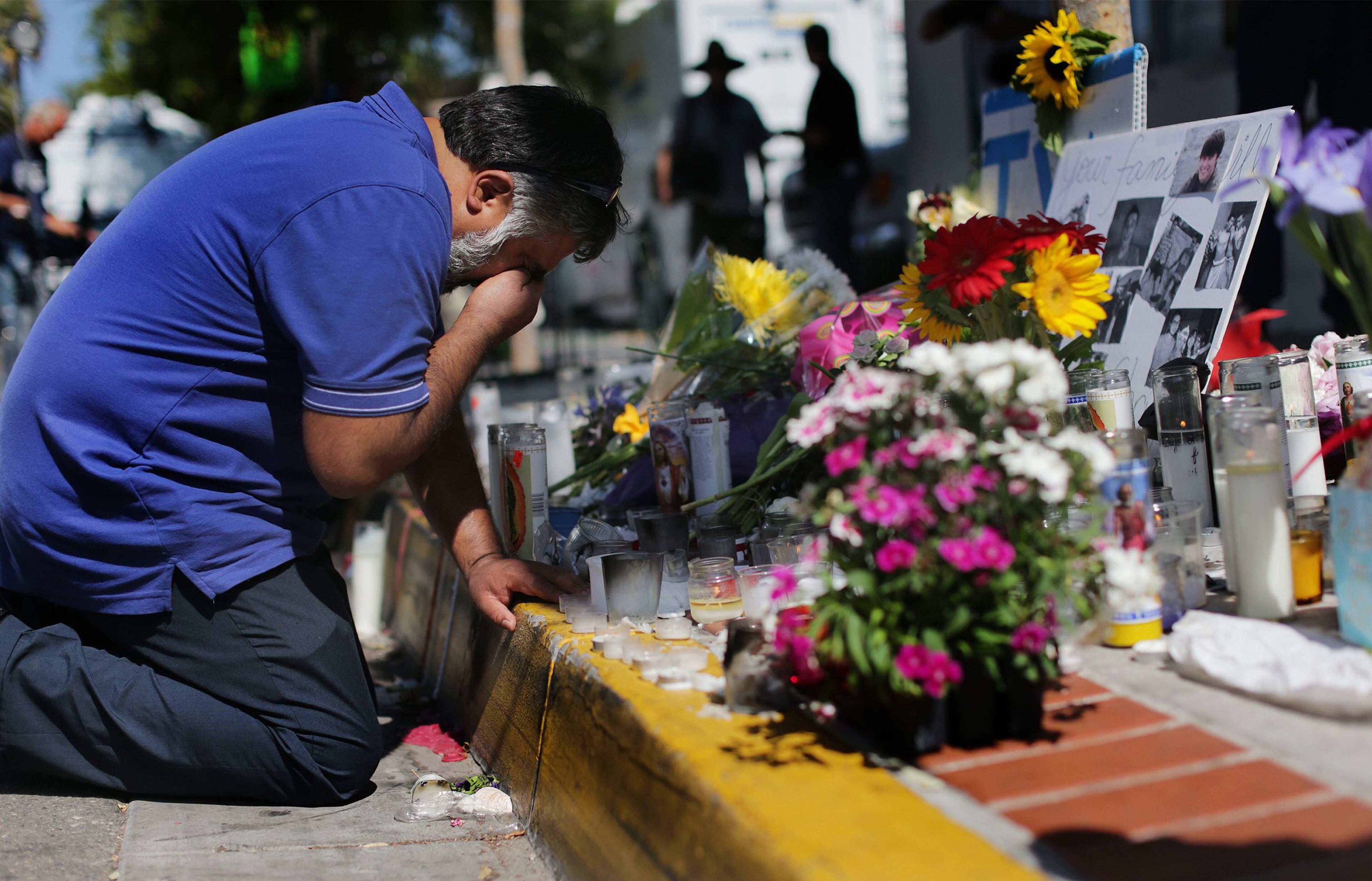 Jose Cardoso, 50, of Isla Vista, Calif., cries and prays as he kneels next to flowers in front of the Alpha Phi sorority house on Sunday, May 25, 2014. (Gina Ferazzi/Los Angeles Times/MCT)