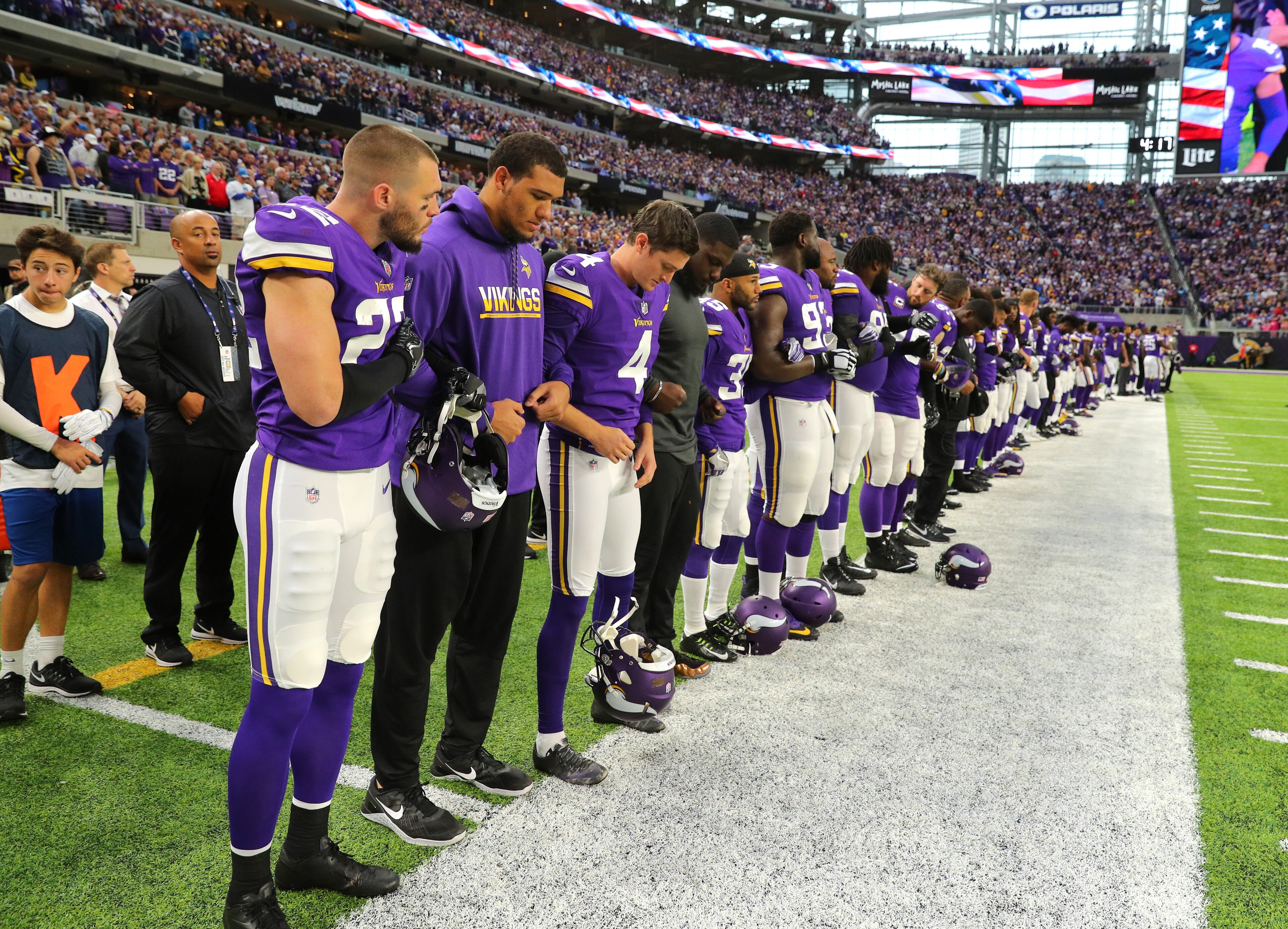 MINNEAPOLIS, MN - OCTOBER 1: Minnesota Vikings players link arms during the national anthem before the game against the Detroit Lions on October 1, 2017 at U.S. Bank Stadium in Minneapolis, Minnesota. (Photo by Adam Bettcher/Getty Images)