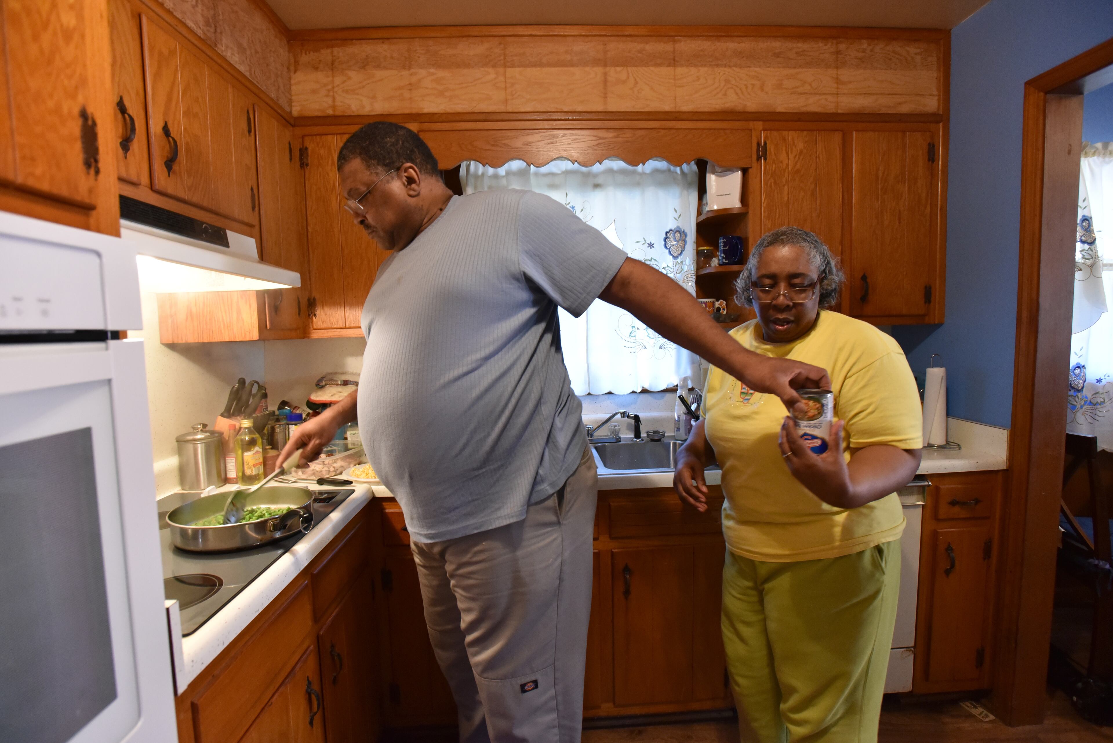 Lavern and Bonita Evans cook a dinner of chicken with spring vegetables following a recipe that was provided by HEALing Community Center at their home in College Park. The Evans, who suffer from obesity, diabetes and hypertension, live in one of Georgia's 35 food deserts, which experts say weigh heavily on the state's chronic disease burden, costing it billions of dollars annually in diabetes care, treatment and management alone. HYOSUB SHIN / HSHIN@AJC.COM