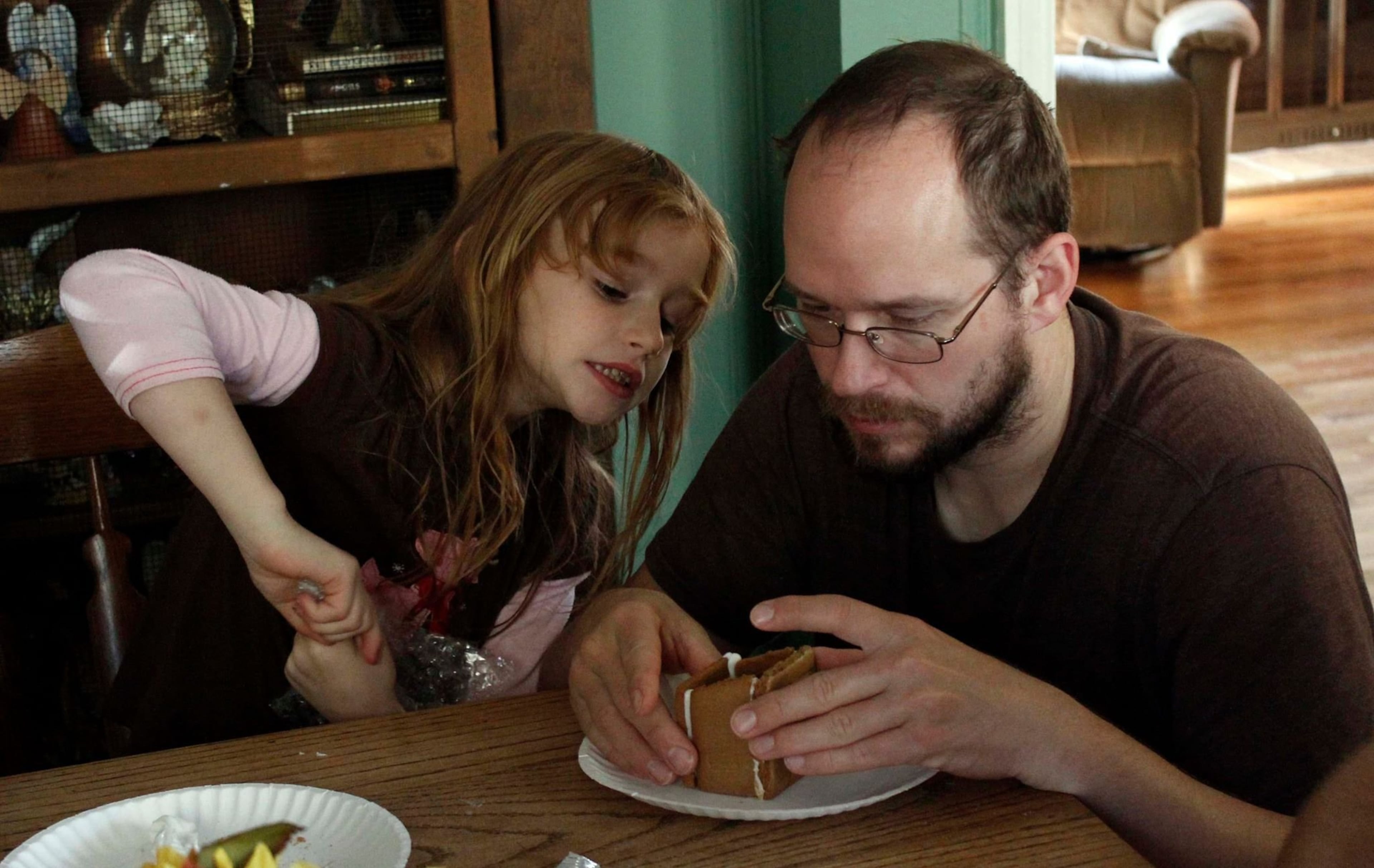Matt Lindsey and SarahBeth working on a gingerbread house.