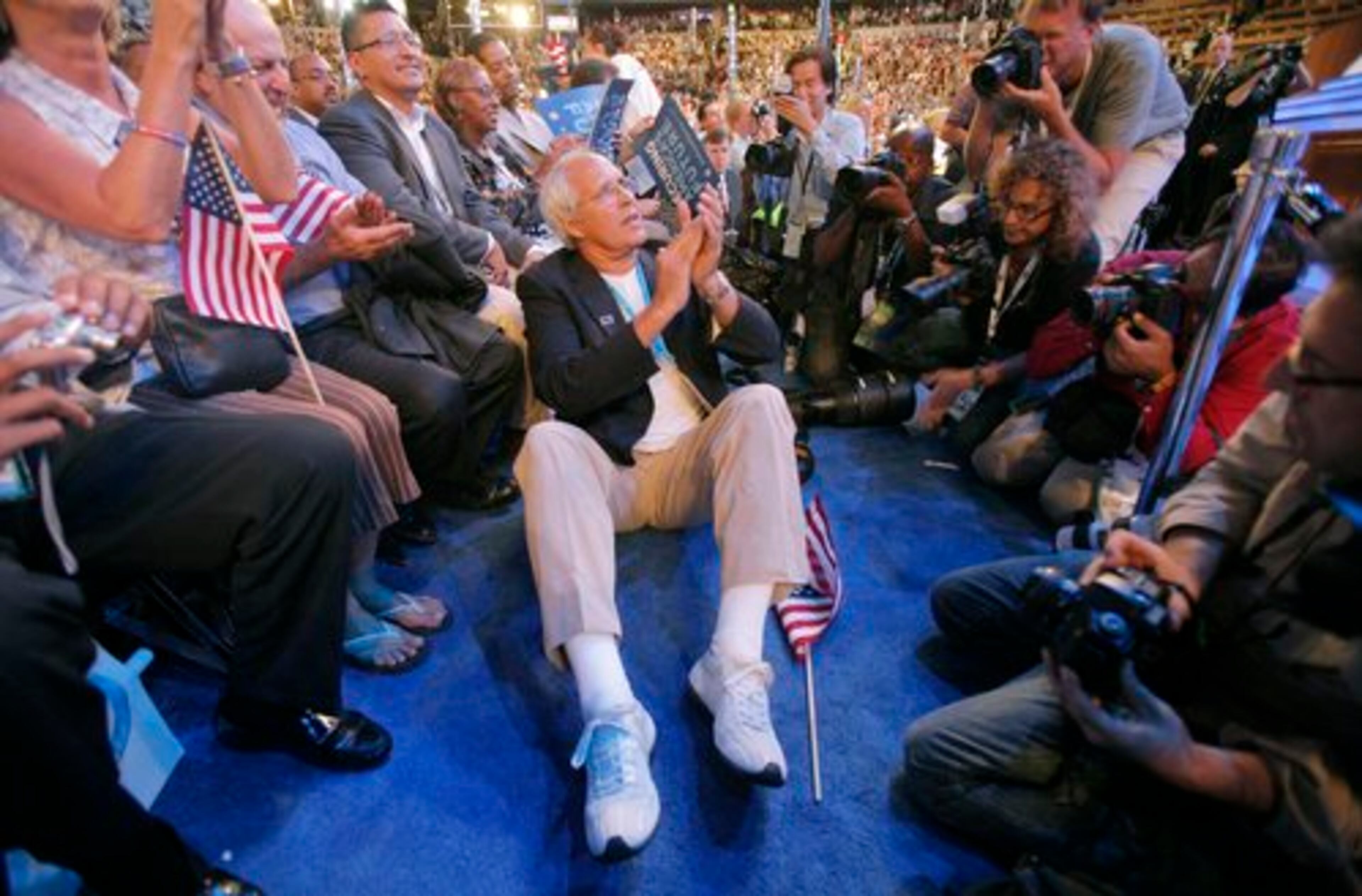 Actor Chevy Chase applauds as he listens to Former President Bill Clinton speak at the Democratic National Convention.