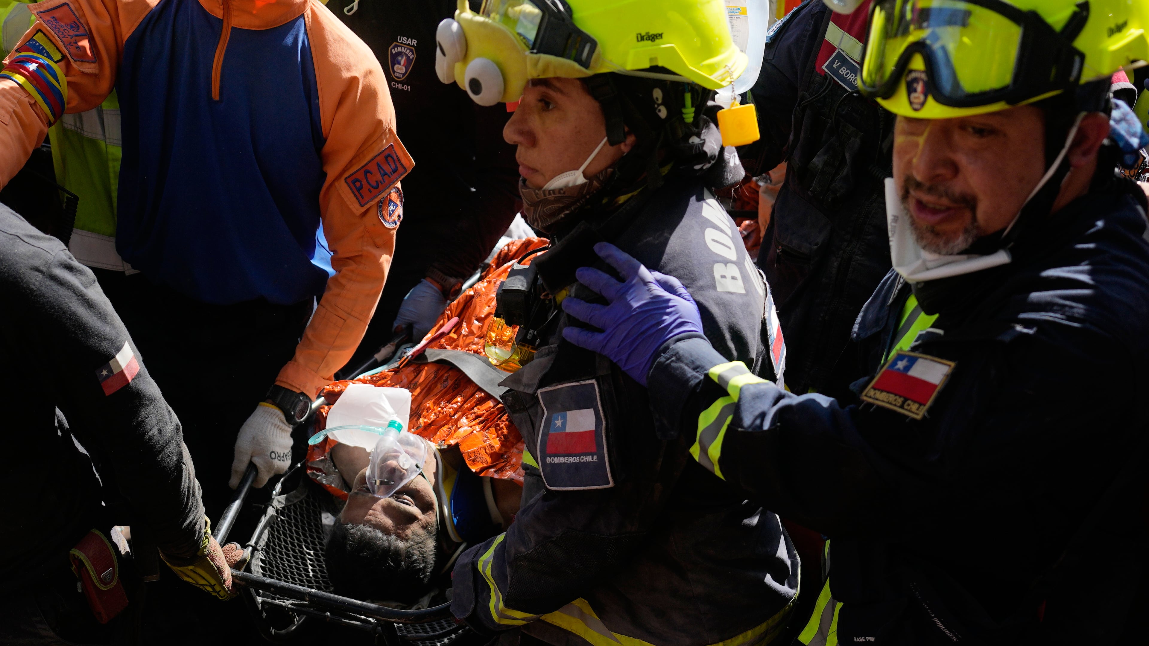 Chilean rescue workers carry Hernán Alberto Gil Flores after he was pulled from the rubble eight days after he was trapped by twin earthquakes that struck Catia La Mar, Venezuela, Thursday, July 2, 2026. (AP Photo/Fernando Vergara)