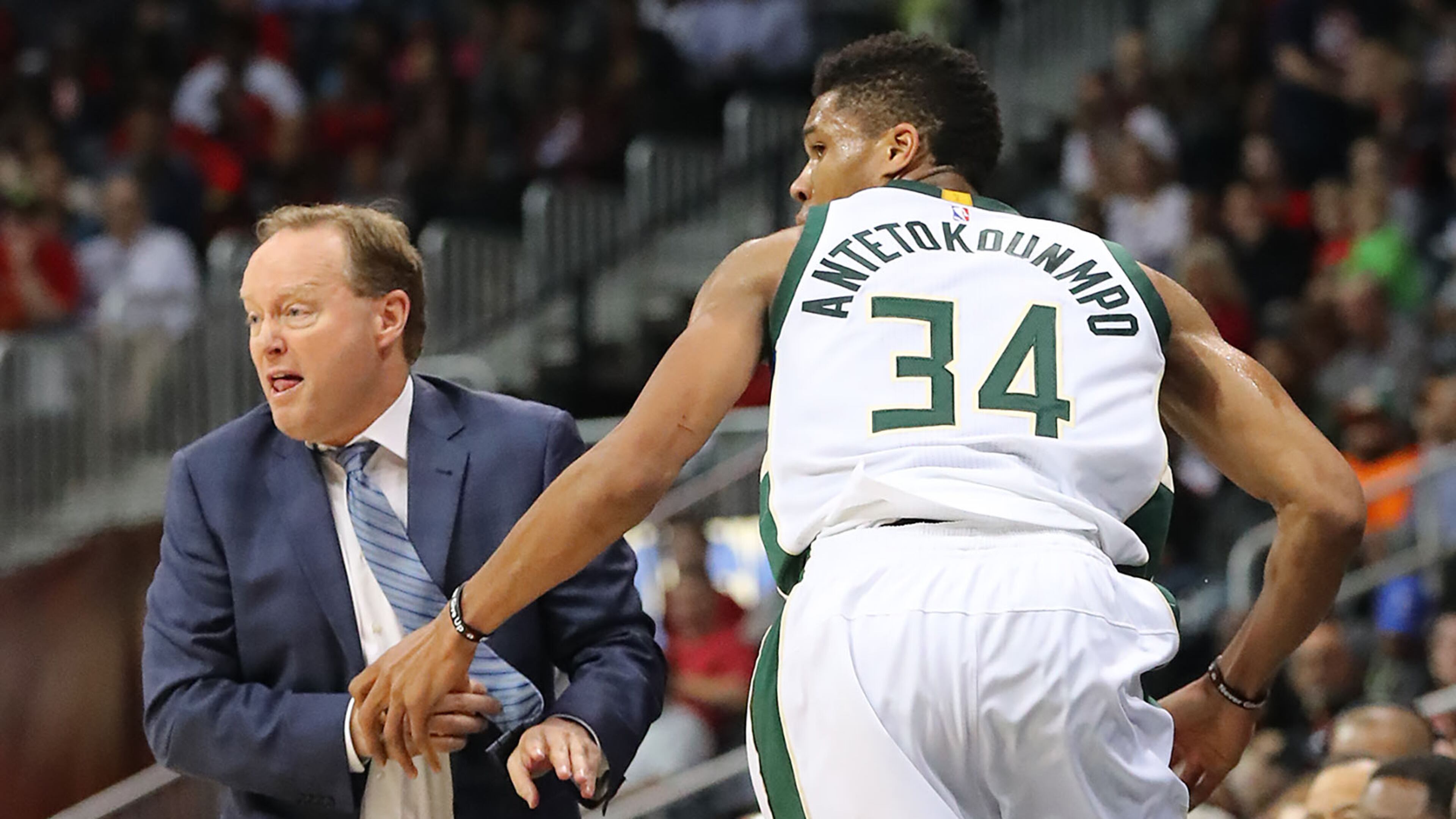 Bucks’ Giannis Antetokounmpo gets tangled up with Hawks head coach Mike Budenholzer in a NBA basketball game on Sunday, Jan. 15, 2017, in Atlanta. Curtis Compton/ccompton@ajc.com