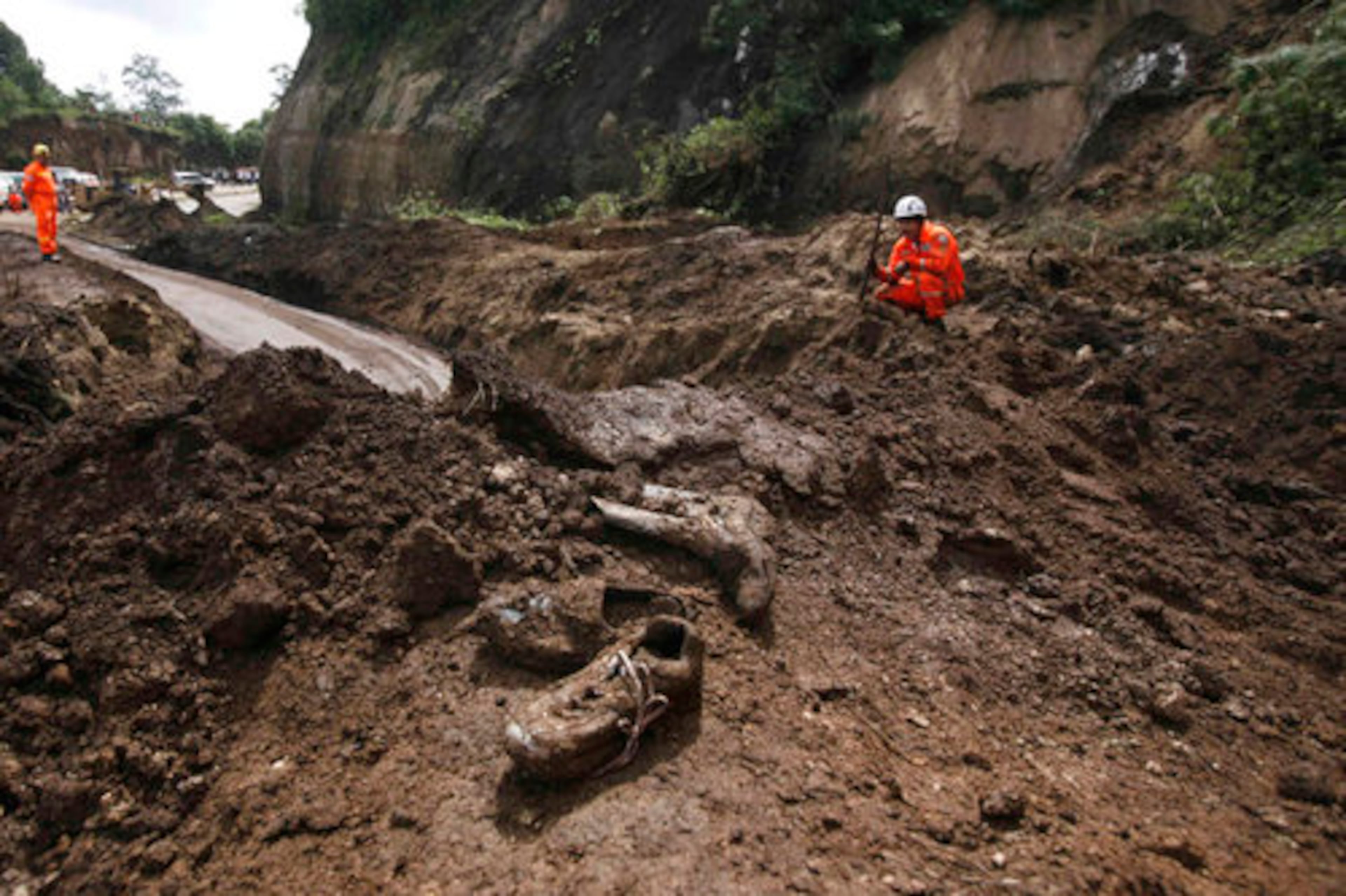 Sept. 5, Nahuala, Guatemala - Torrential rains from a tropical depression saturated the ground in parts of Guatemala and unleashed more than a dozen landslides, killing at least 38 people and leaving many more unaccounted for. Firefighters confirmed at least 20 dead in the village of Nahuala, where twin slides hit a section of the Inter-American highway. About 50 more were believed buried under tons of rubble.