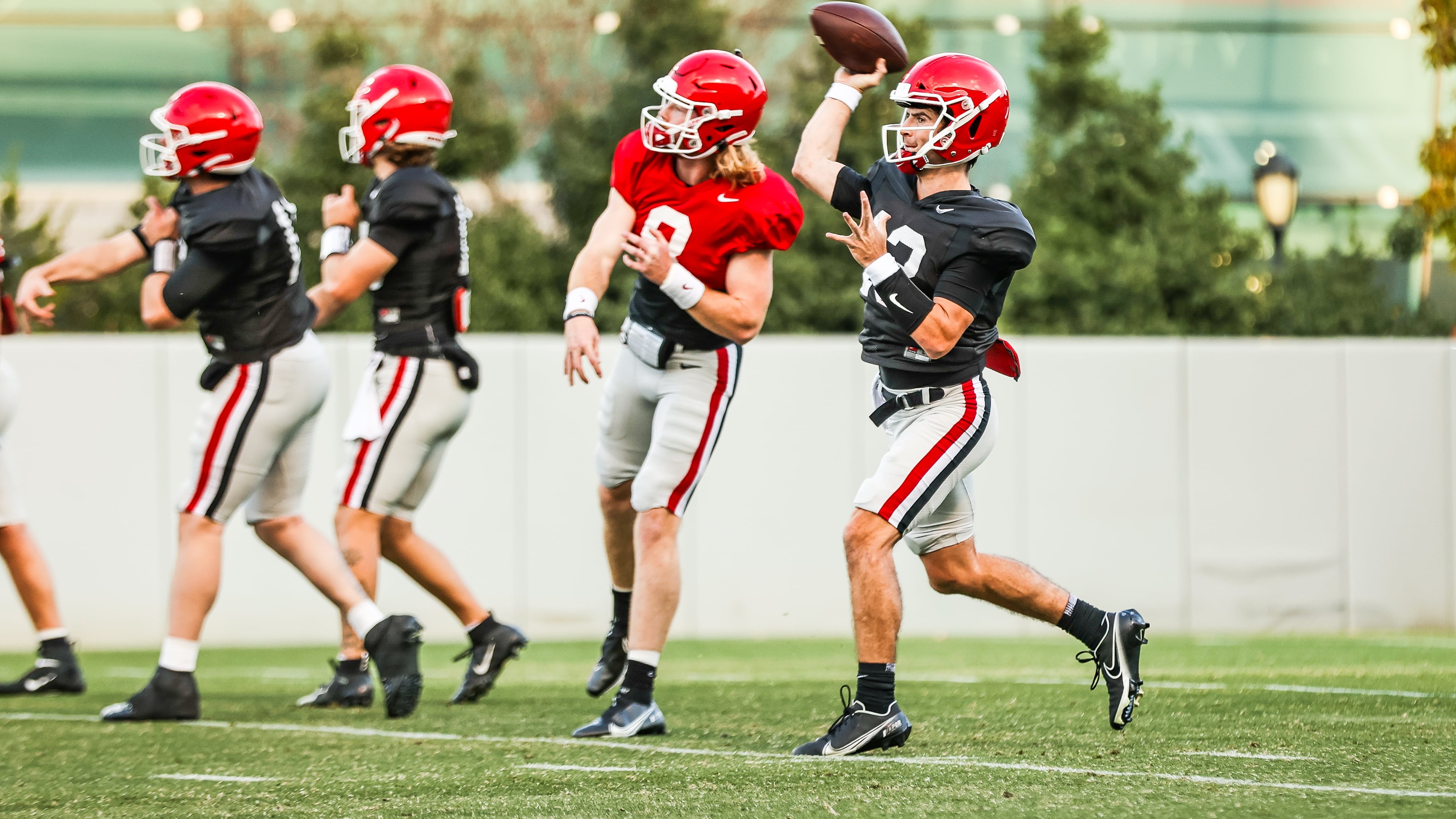 Georgia's quarterbacks, including senior starter Stetson Bennett (right), warm up early in practice on Tuesday, Nov. 16, 2021 at Woodruff Practice Fields (Photo by Tony Walsh/UGA Athletics)