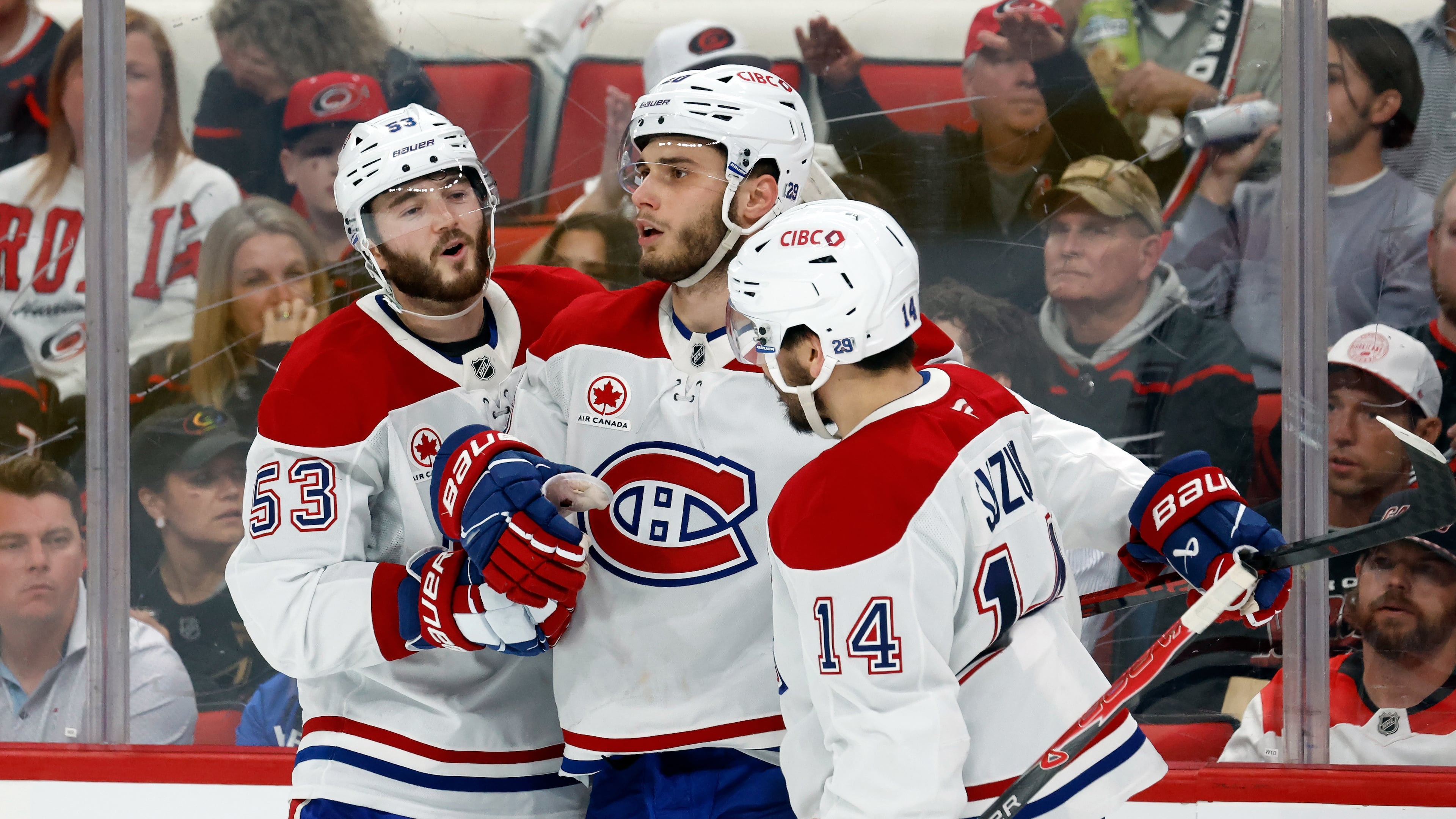 Montréal Canadiens' Juraj Slafkovský (20), center, celebrates his goal with Nick Suzuki (14) and Noah Dobson (53) during the third period in Game 1 of the Eastern Conference finals NHL hockey Stanley Cup playoffs series against the Carolina Hurricanes in Raleigh, N.C., Thursday, May 21, 2026. (AP Photo/Karl DeBlaker)
