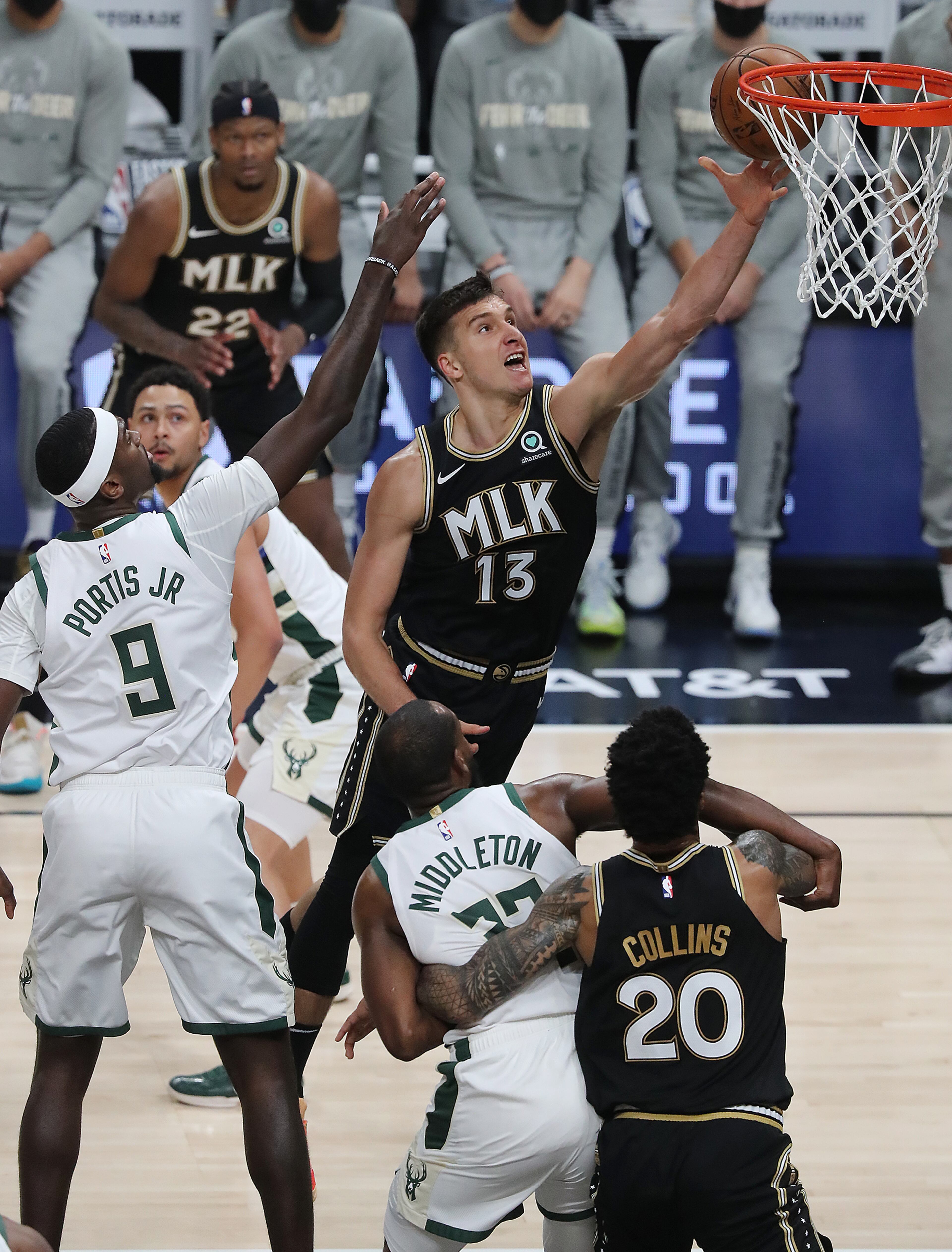 Hawks guard Bogdan Bogdanovic goes to the basket for two past Milwaukee Bucks defender Bobby Portis during the first quarter in game 6 of the NBA Eastern Conference Finals on Saturday, July 3, 2021, in Atlanta. “Curtis Compton / Curtis.Compton@ajc.com”