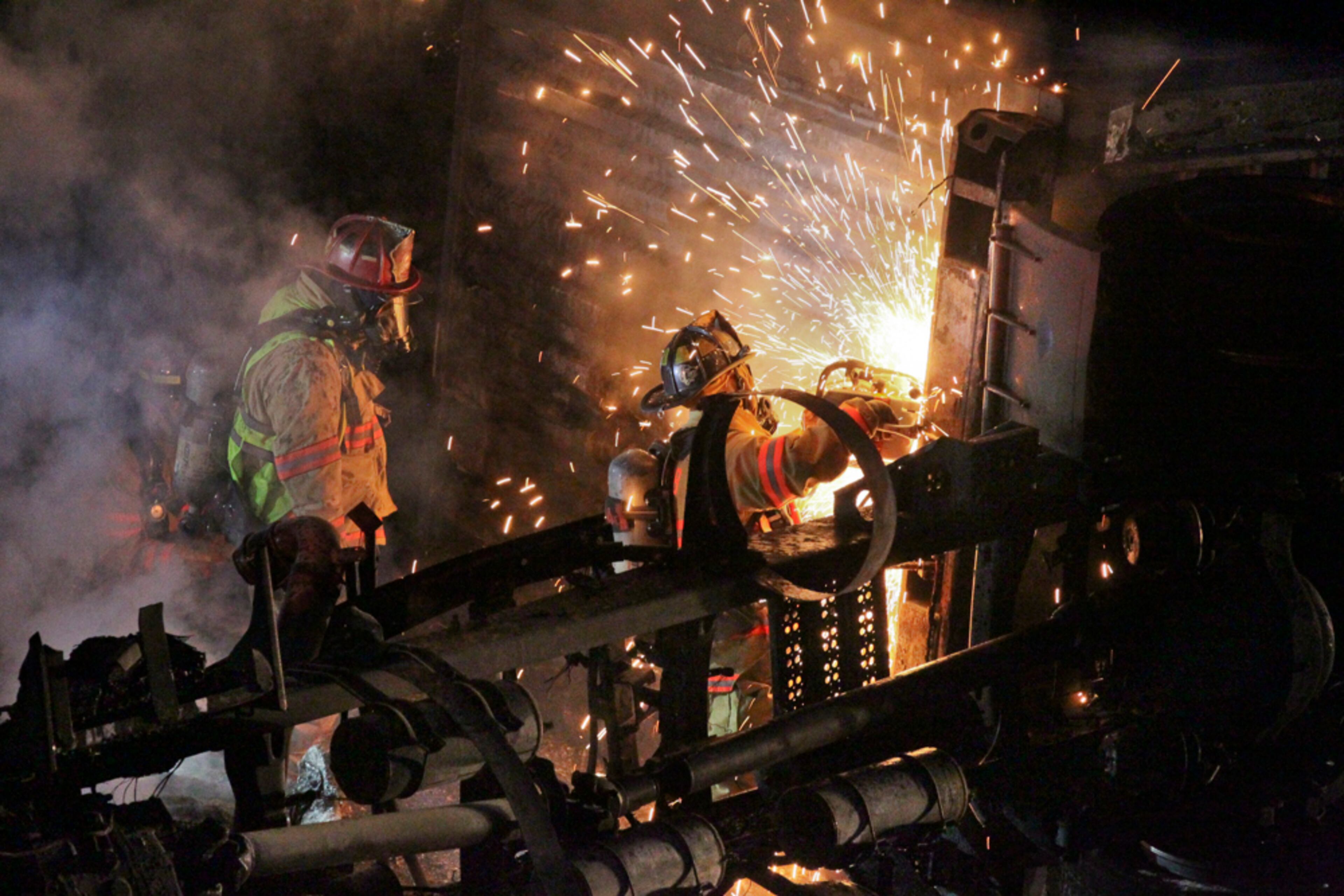 SECONDARY PHOTO - Apr. 29, 2013 Cobb County : Cobb County firefighters use saws to open the tractor trailer to get to the fire. The Cobb County ramp from I-285 eastbound to I-75 northbound was reopened, hours after a tractor-trailer wreck completely shut down the ramp Monday, Apr. 29, 2013. The truck overturned and caught fire around 5 a.m. on the ramp from I-285 eastbound to I-75 northbound. Police closed that ramp while fire crews doused the fire. The fire was extinguished by around 5:30, but it was nearly 8:30 before authorities were able to open one of the two ramp lanes. The ramp from I-285 westbound to I-75 southbound was also shut down around 5:30 a.m. while authorities inspected that ramp’s overpass for damage from the fire, which burned under the bridge. That ramp had reopened by 6:45 a.m. According to the Georgia State Patrol, the truck’s driver, Hanson Tunsil, 54, of Jacksonville, Fla., and a passenger in the truck, were taken to Wellstar Kennestone Hospital for treatment. The extent of their injuries was not immediately known. JOHN SPINK / JSPINK@AJC.COM