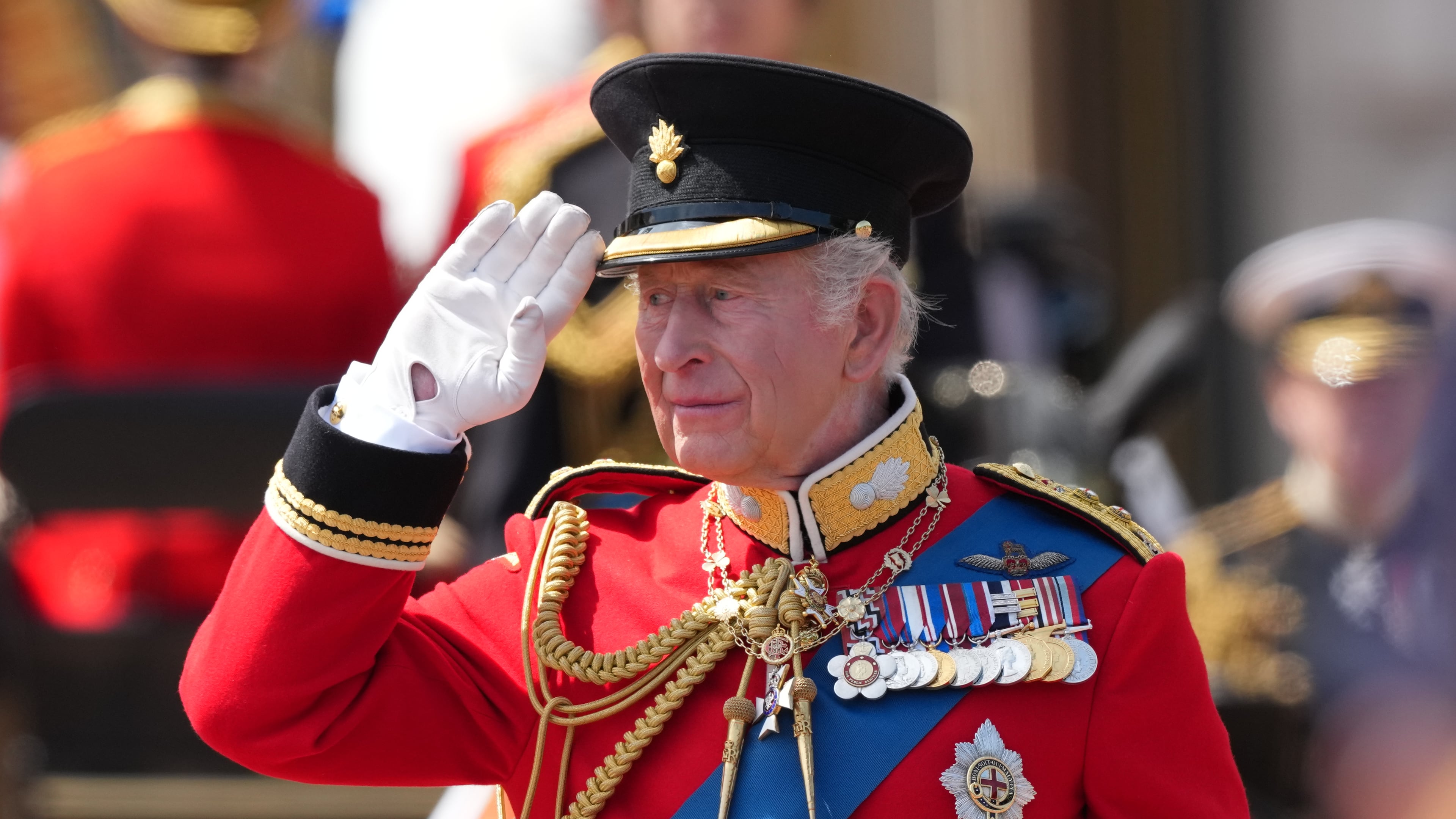 Britain's King Charles III salutes the troops outside Buckingham Palace during Trooping The Colour, the King's annual birthday parade, in London, Saturday, June 13, 2026. (AP Photo/Kirsty Wigglesworth)