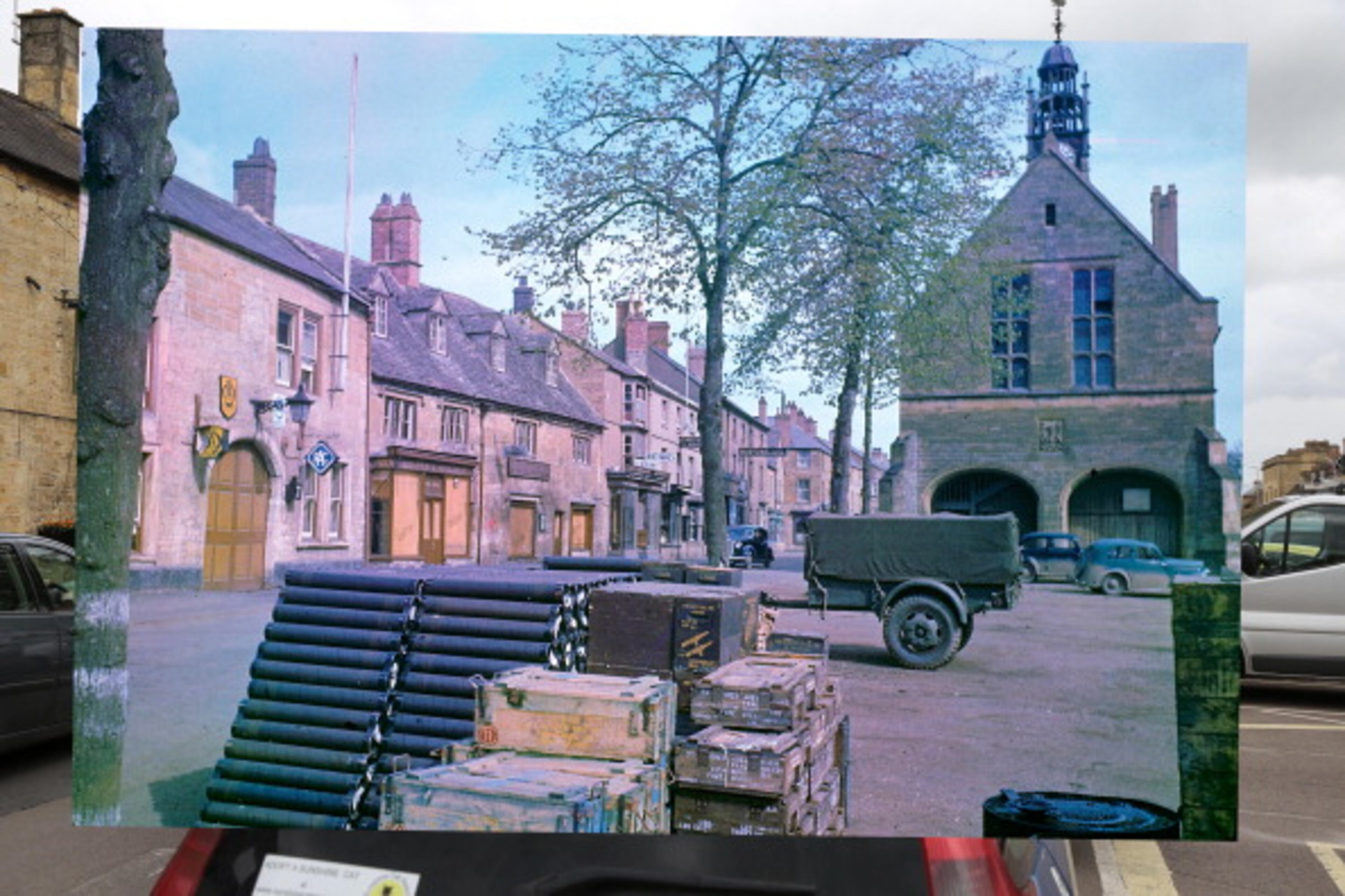 In this composite image a comparison has been made of Moreton in Marsh, England. D-Day took place on June 6, 1944. *** COLOR 2014*** Image #493778241. MORETON ON MARSH, ENGLAND - MAY 12: A general view of the high street on May 12, 2014 in Moreton in Marsh, England. The Allied invasion to liberate mainland Europe from Nazi occupation during World War II took place on June 6, 1944. Operation Overlord, known as D-Day, was the largest sea borne invasion in military history. (Photo by Peter Macdiarmid/Getty Images) ***ARCHVE 1944*** Image #56607969. A vew of a town square, stockpiled with supplies and ammunition earmarked for the impending D-Day invasion of France, Moreton-in-Marsh, England, May 1944. The building at the extreme left is the Rededale Arms Hotel. (Photo by Frank Scherschel/Time & Life Pictures/Getty Images)