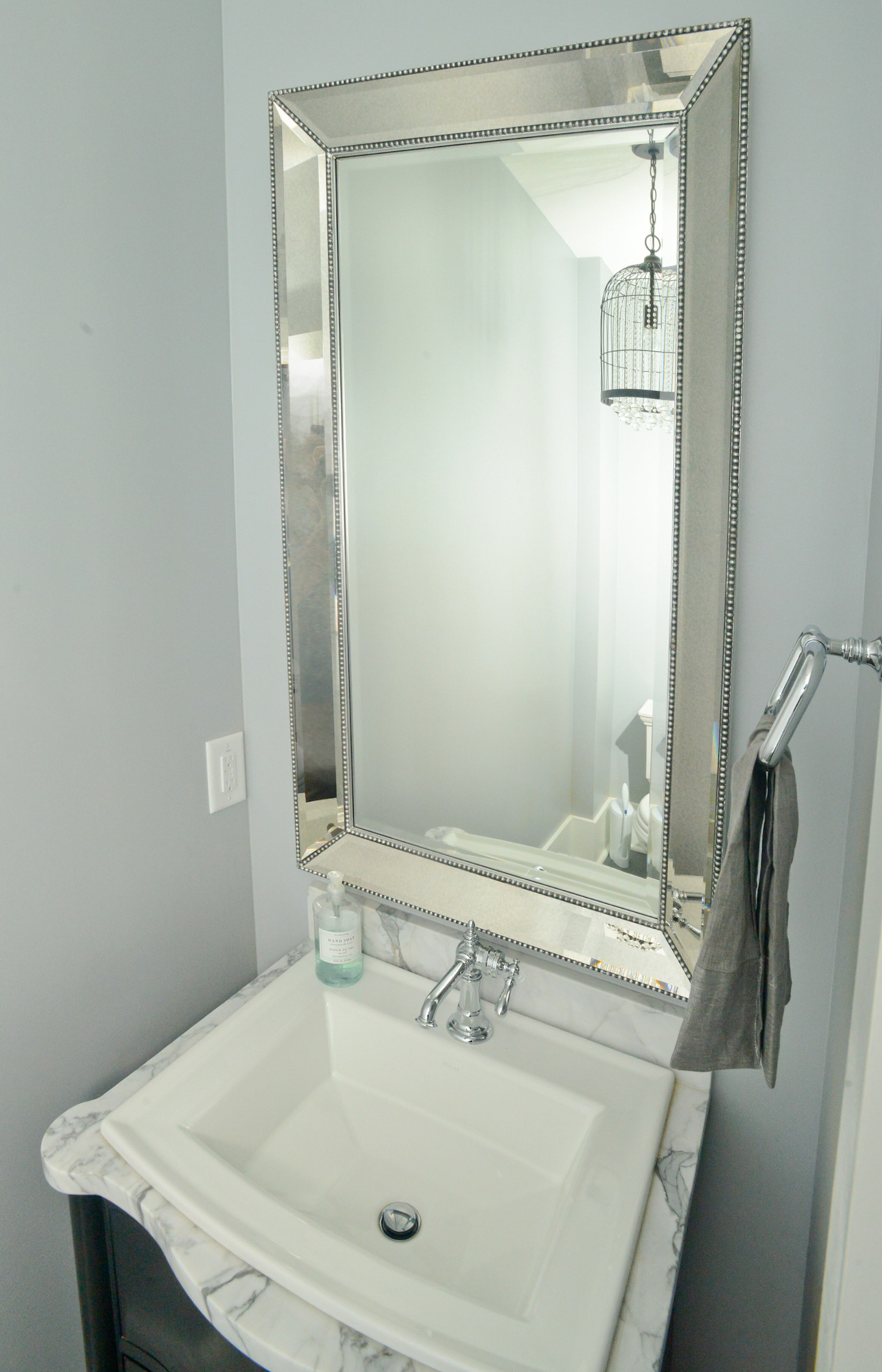 "We have a lot of gray in our house," says homeowner Lauren Kane, whose chose subtle muted colors for every room, including the powder room downstairs.