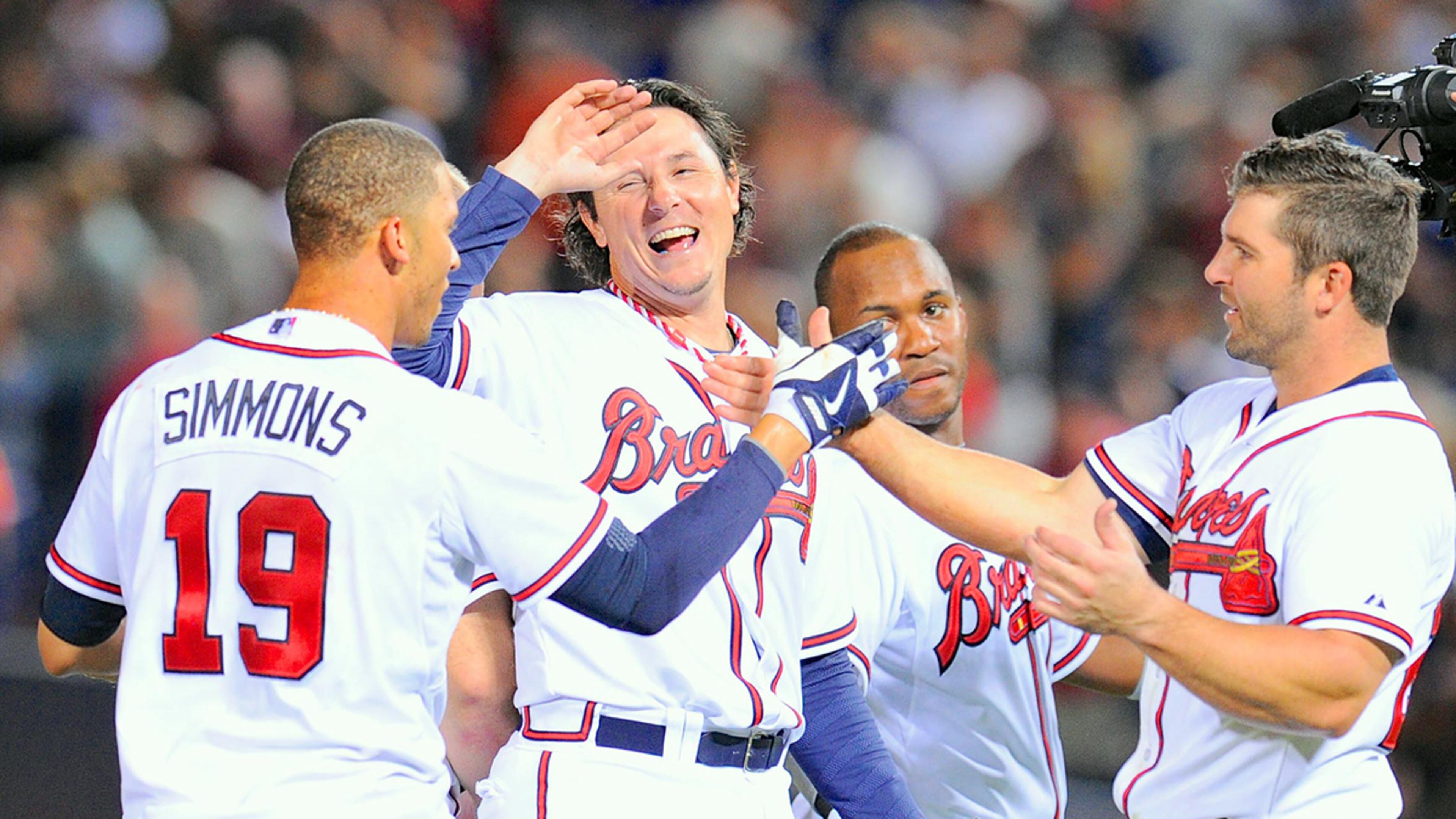 New Braves reliever Scott Downs (center) celebrates comeback win with teammates after a rally in the 10th gave the former Los Angeles Angels pitcher his first win in Atlanta.