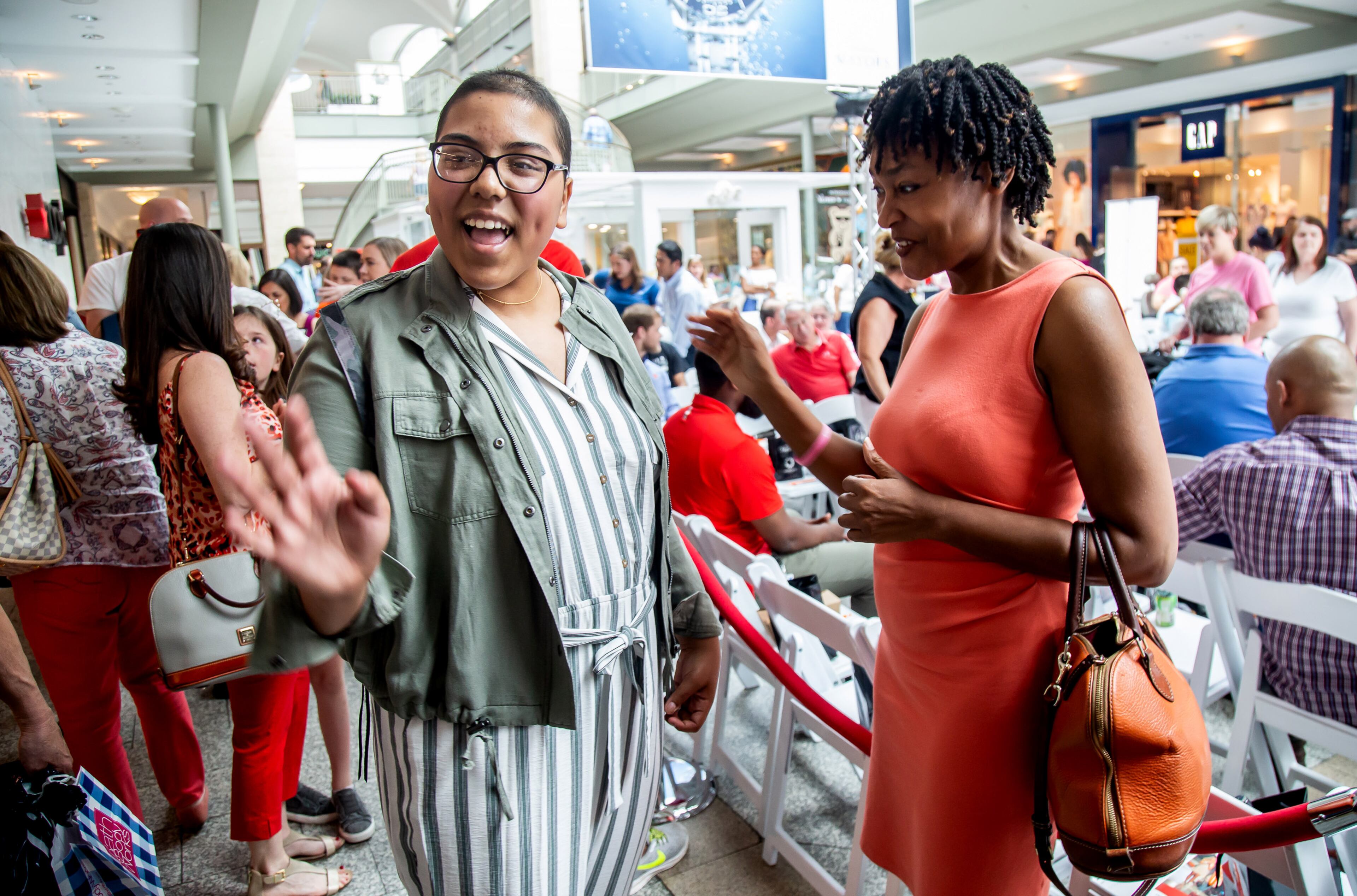 Jacqueline Hernandez talks with her mentor, small business owner, Barbra Jones before the start of Fashion Funds the Cure, a fashion show benefiting The National Pediatric Cancer Foundation at Lenox Square in Atlanta on Saturday, May 4, 2019. STEVE SCHAEFER / SPECIAL TO THE AJC