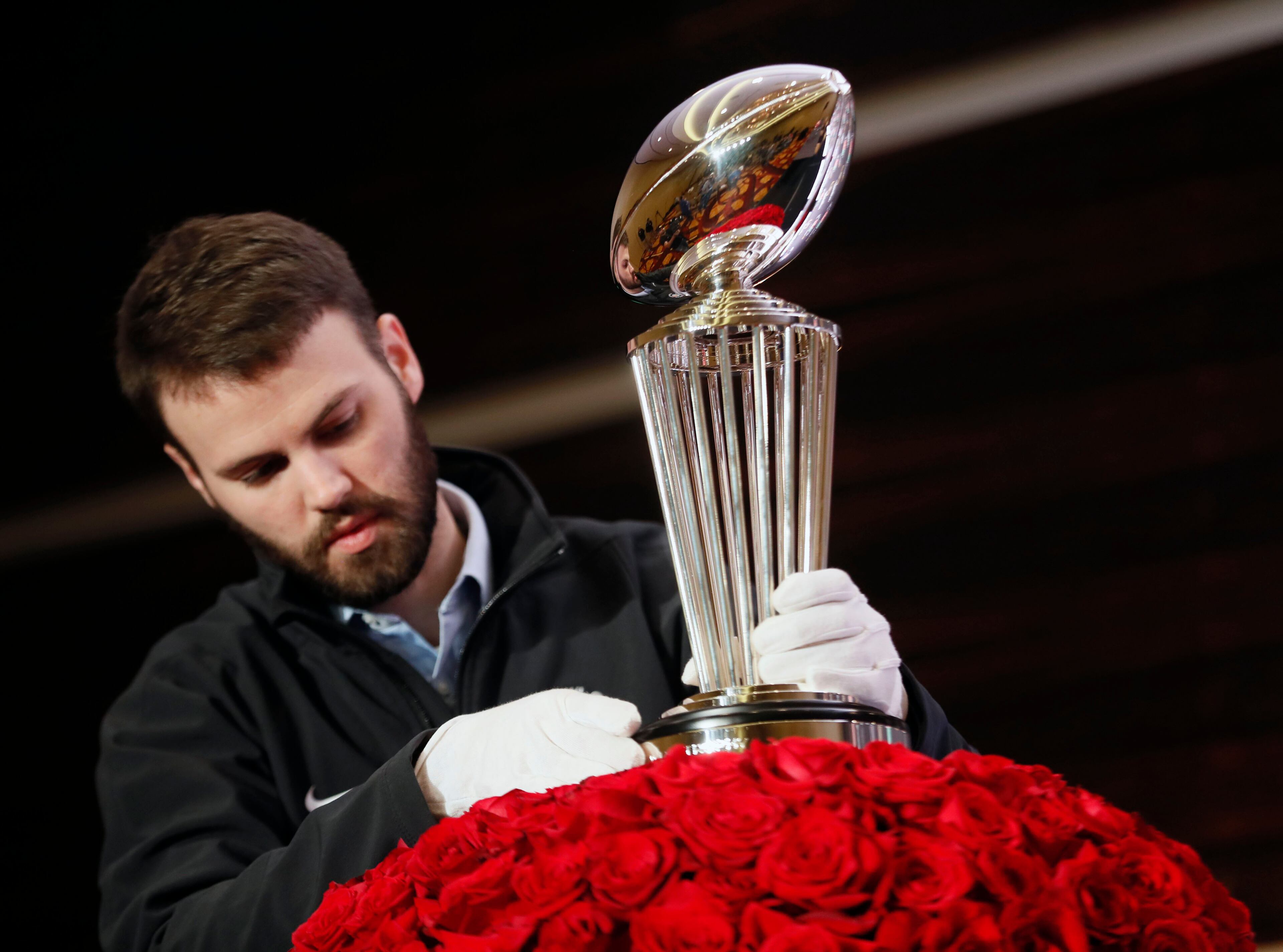 12/31/17 - Los Angeles - Rose Bowl official Doug Ingels places the Rose Bowl trophy in advance of this morning's media conference. Georgia head coach Kirby Smart and Oklahoma head coach Lincoln Riley appeared together at a media press conference and photo session with the Rose Bowl trophy. Georgia plays Oklahoma in a NCAA football playoff game on Monday, and a victory there, will put the Bulldogs in Mercedes-Benz Stadium on Jan. 8 to play one of two rivals -- Alabama or Clemson -- for the national title. BOB ANDRES /BANDRES@AJC.COM