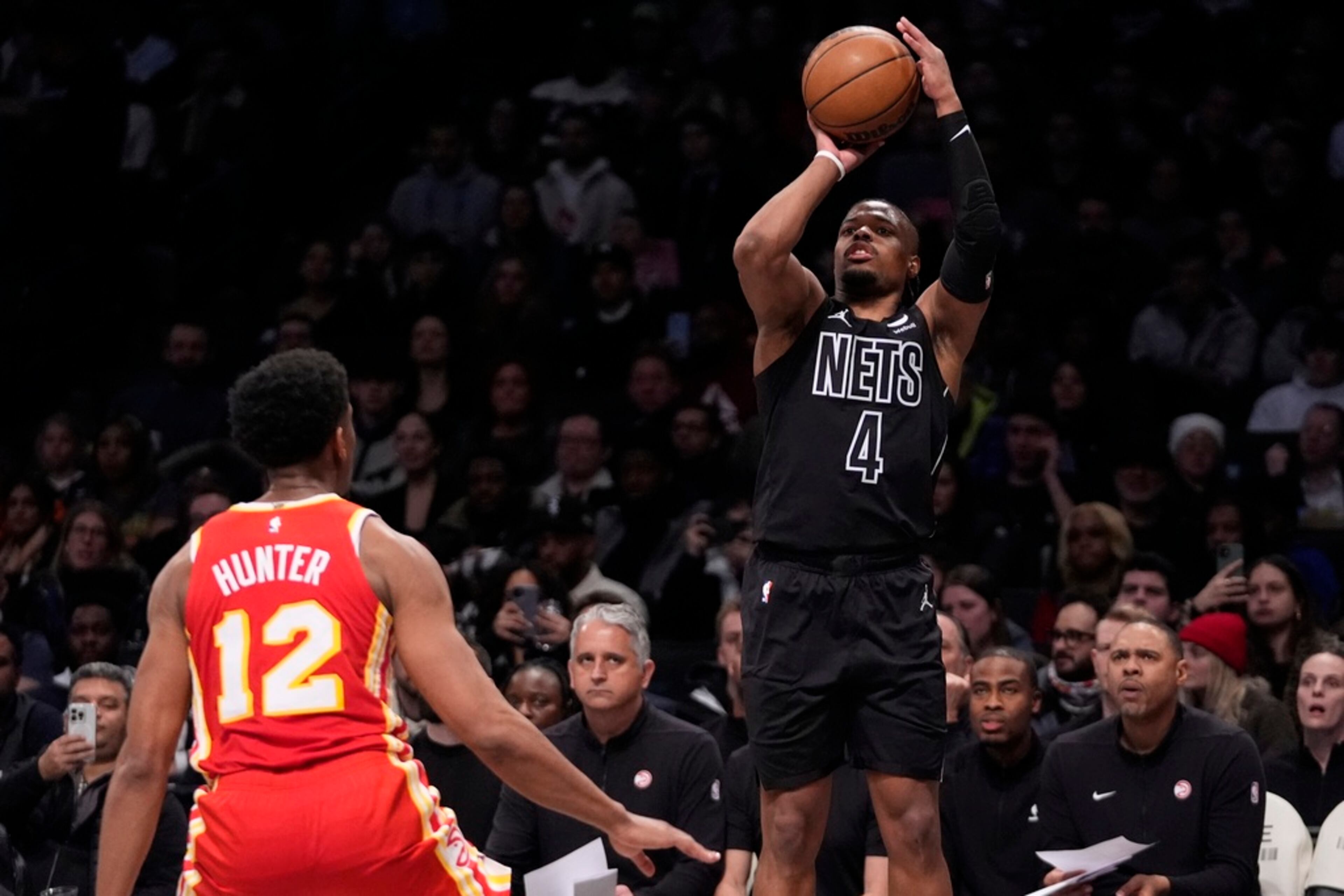 Brooklyn Nets' Dennis Smith Jr. (4) shoots over Atlanta Hawks' De'Andre Hunter (12) during the second half of an NBA basketball game Thursday, Feb. 29, 2024, in New York. (AP Photo/Frank Franklin II)