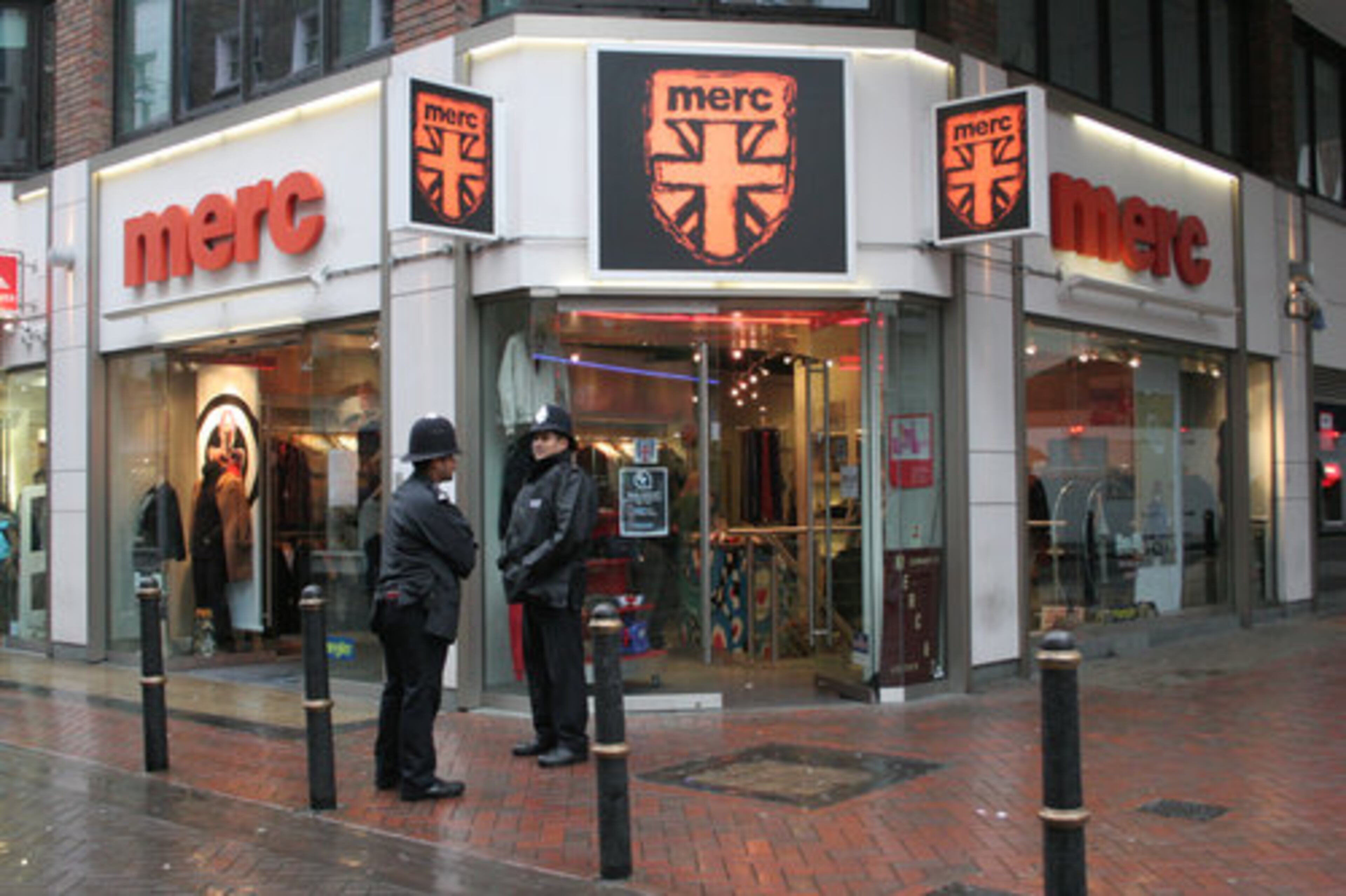 Two bobbies stand outside the entrance to Merc, a mainstay of Carnaby Street's British mod look.