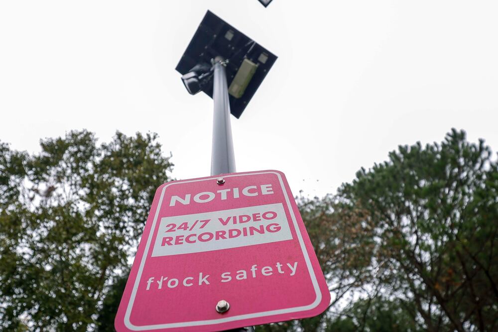 A sign indicates the location of a Flock Safety camera on Great River Parkway Southeast in Lawrenceville earlier this month. (Miguel Martinez/AJC)