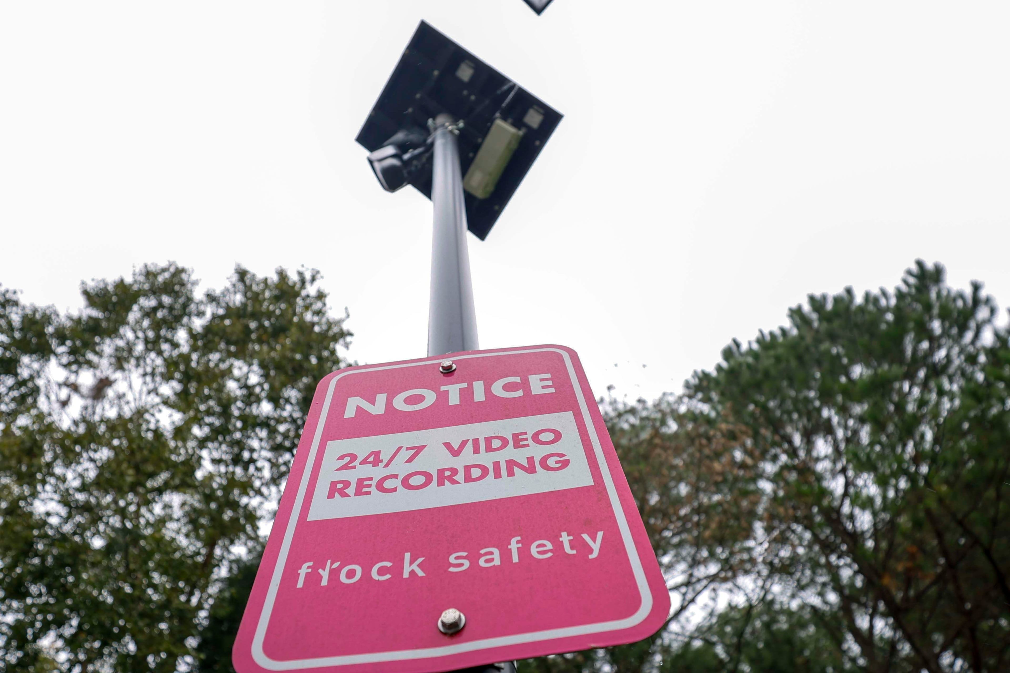 A sign indicates the location of a Flock Safety camera on Great River Parkway Southeast in Lawrenceville earlier this month. (Miguel Martinez/AJC)