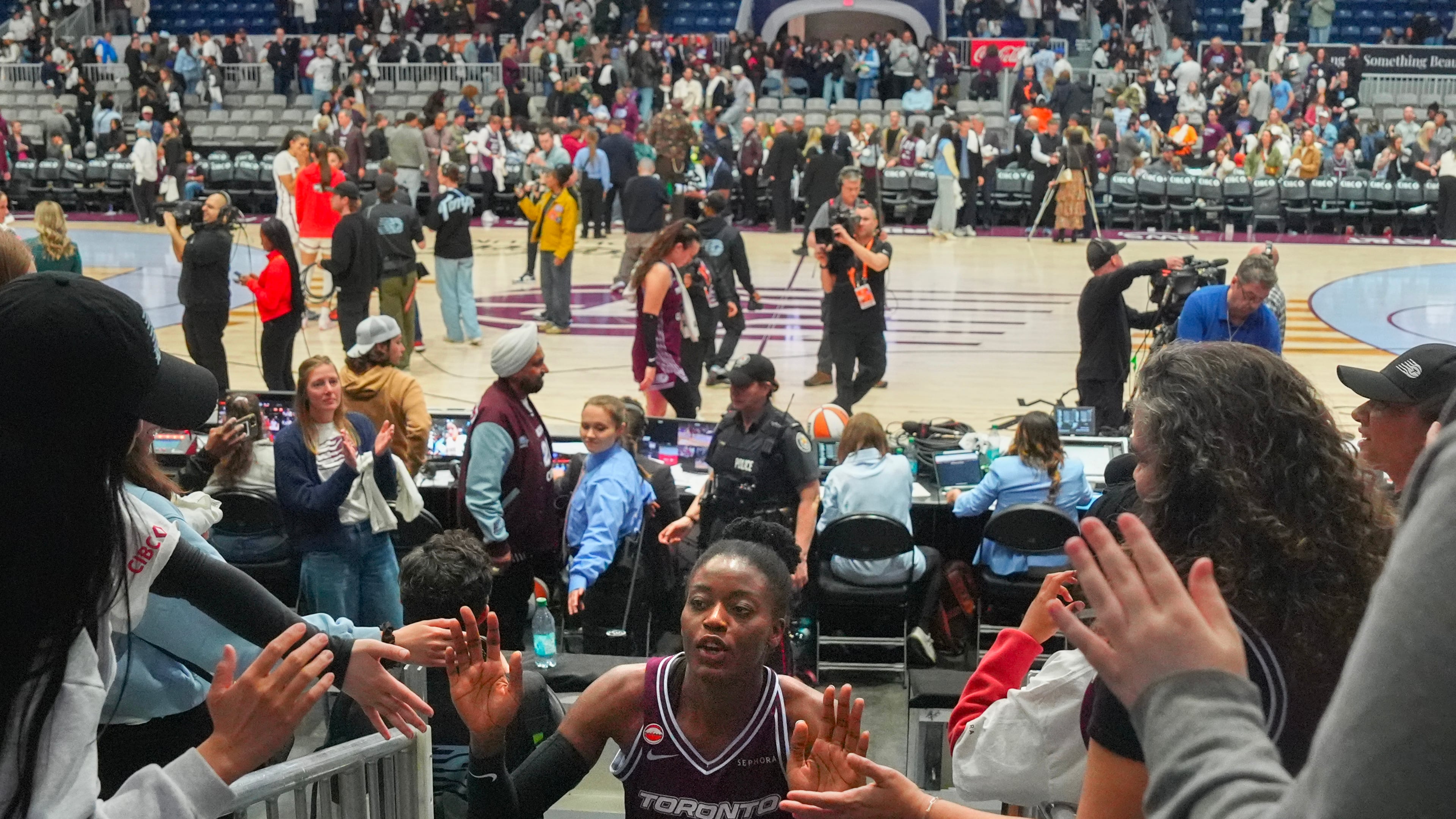Toronto Tempo's Temi Fagbenle (14) high-fives fans as she comes off the court after her team's first WNBA basketball game, aganst the Washington Mystics, in Toronto, Friday, May 8, 2026. (Chris Young/The Canadian Press via AP)