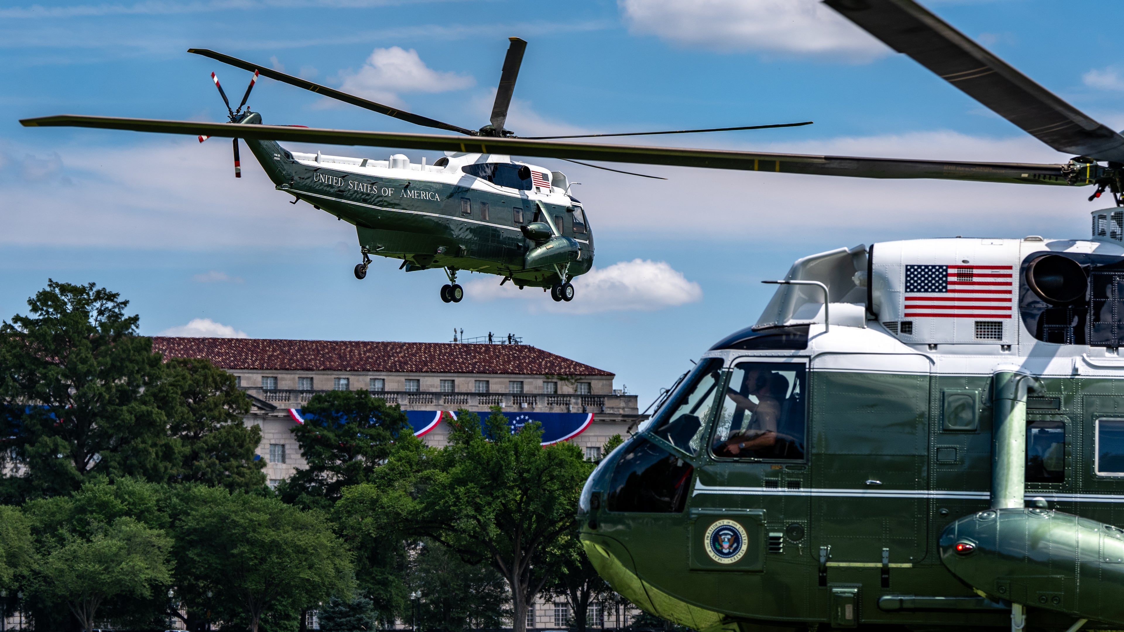 Marine One, left, with President Donald Trump aboard, lifts off from the Ellipse, Tuesday, Aug. 4, 2026, in Washington. (AP Photo/Alex Brandon)