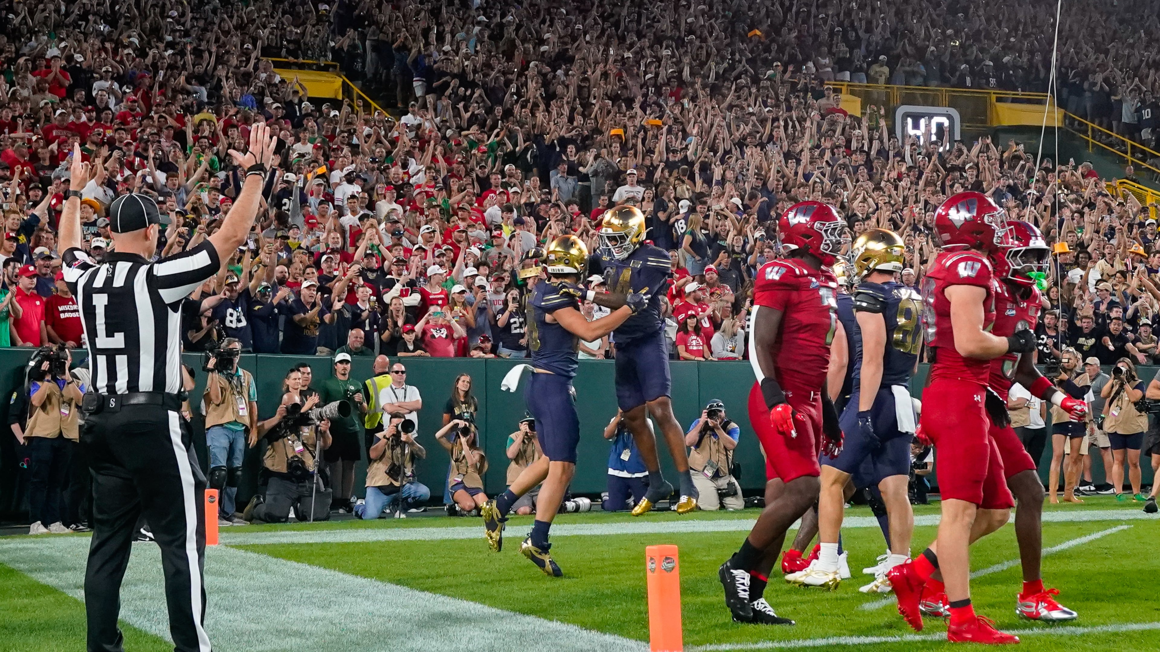 Notre Dame tight end James Flanigan, center left, and teammate Micah Gilbert, center right, celebrate a touchdown during the first half of an NCAA college football game against Wisconsin Sunday, Sept. 6, 2026, in Green Bay, Wis. (AP Photo/Kayla Wolf)
