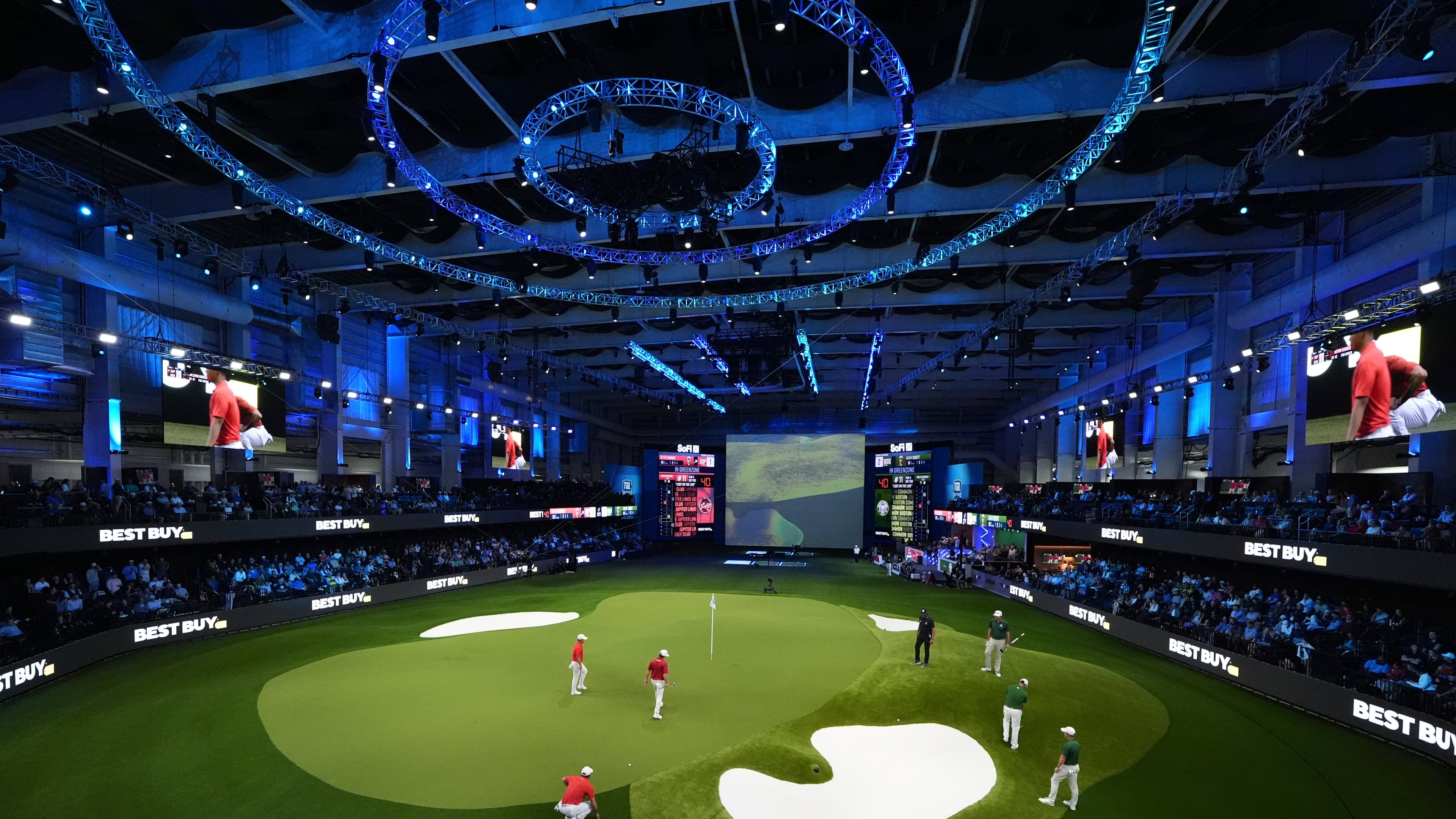 Fans watch play during a match of the TMRW Golf League (TGL) between Jupiter Links Golf Club and Boston Common Golf, Monday, Jan. 27, 2025, in Palm Beach Gardens, Fla. (AP Photo/Rebecca Blackwell)