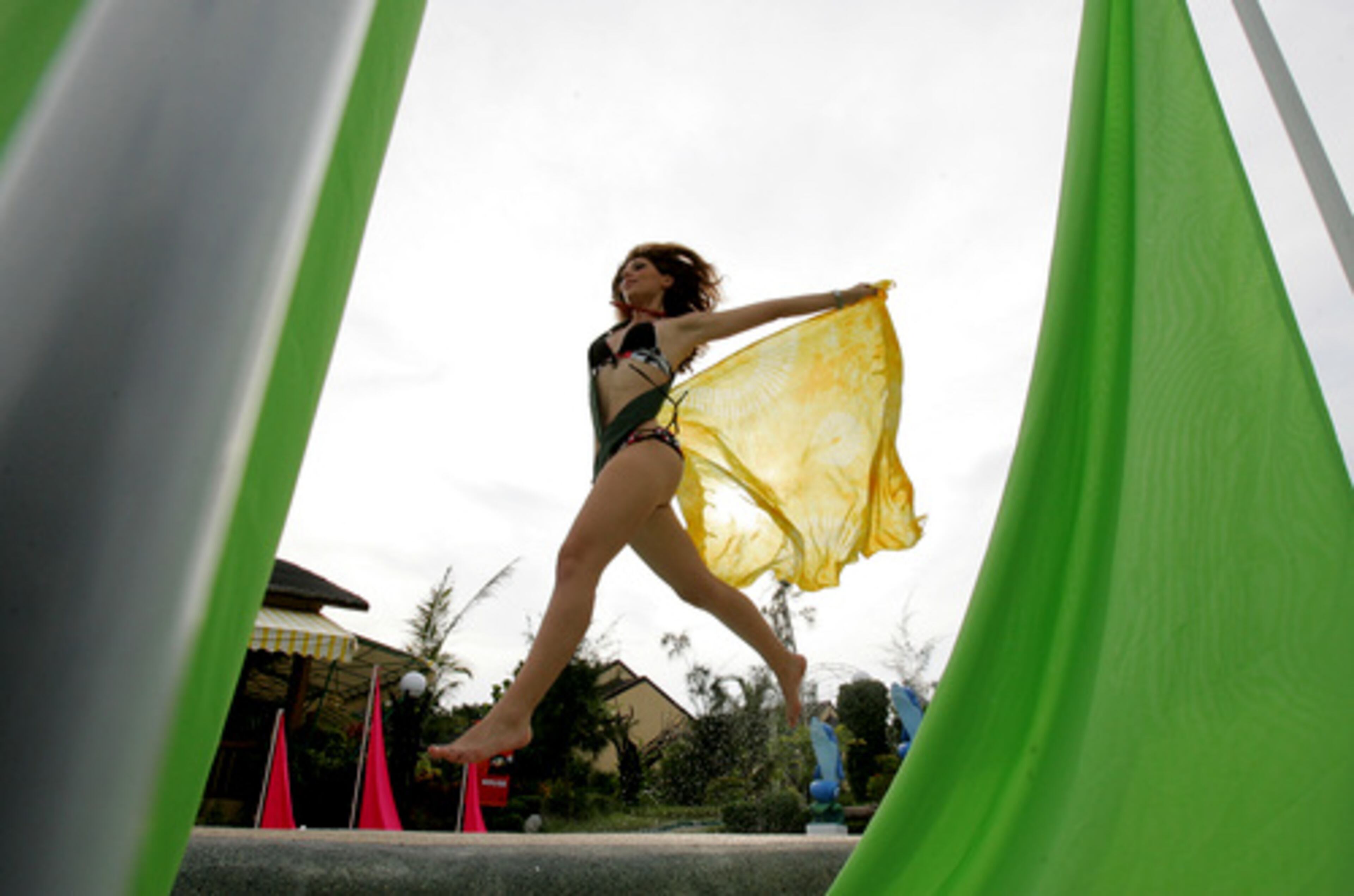 Italy's Bernadette Mazzu leaps during a pictorial of the 2007 Miss Earth beauty pageant by the pool side of the Golden Sunset Resort at Calatagan, Batangas province about 110 kilometers south of Manila, Philippines Sunday Oct. 28, 2007. About 70 candidates are vying for this year's Miss Earth which boasts of the only beauty pageant with a cause to save Mother Earth. Coronation night is November 11, 2007 in Manila, Philippines.