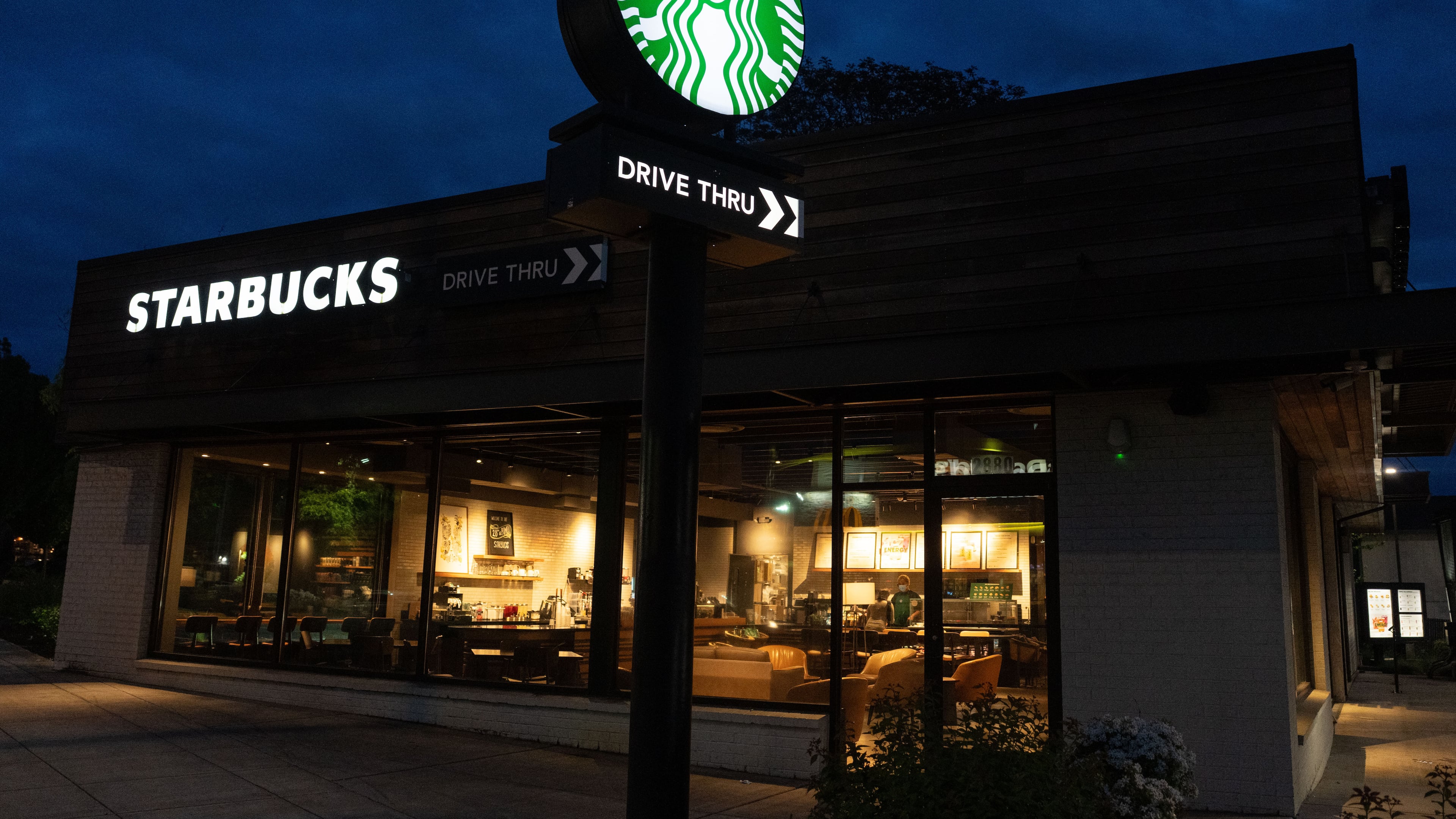 A customer visits a Starbucks location on Monday, April 27, 2026, in Portland, Ore. (AP Photo/Jenny Kane)