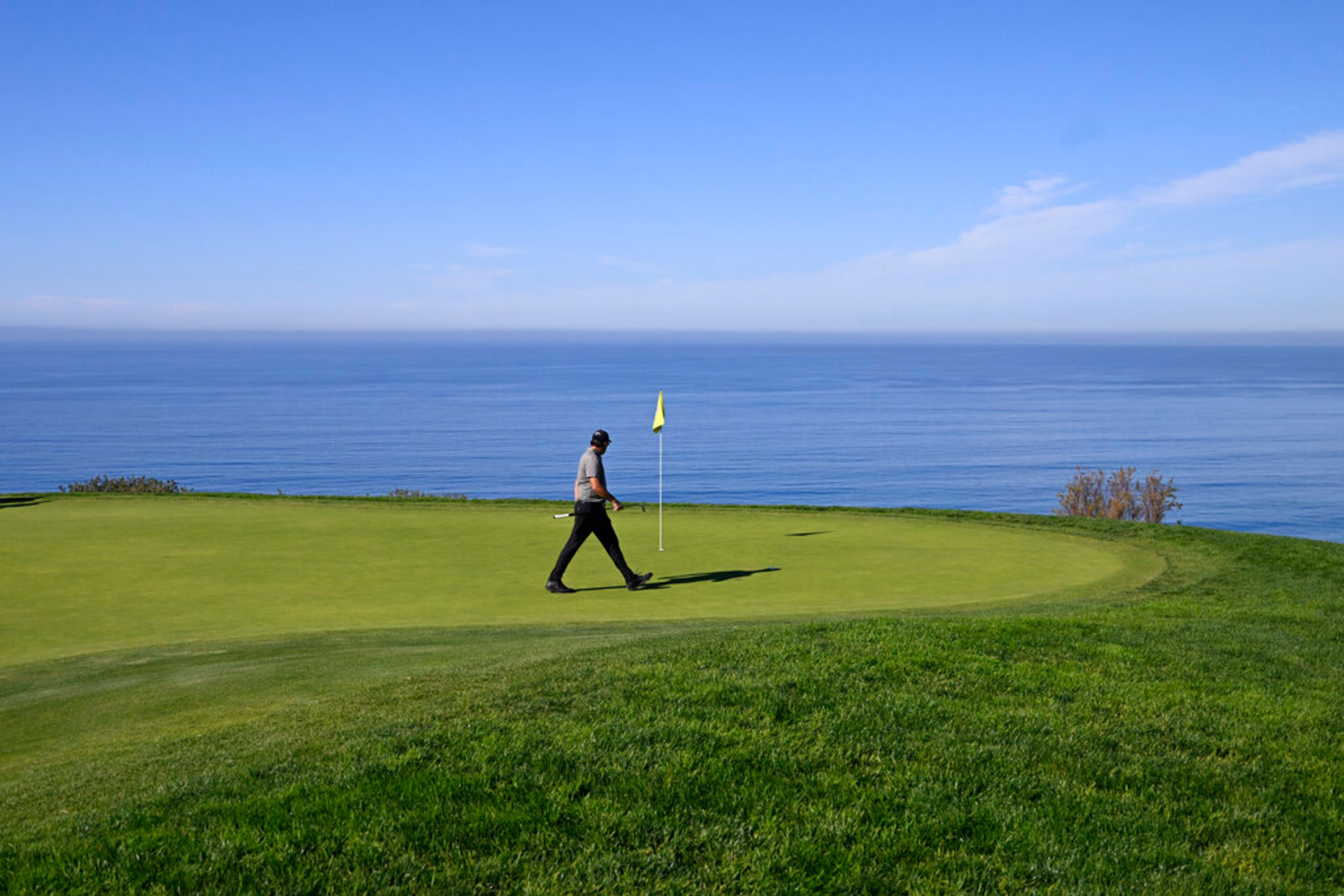 Phil Mickelson walks on the green on the fourth hole of the South Course at Torrey Pines during the first round of the Farmers Insurance Open golf tournament, Wednesday, Jan. 26, 2022, in San Diego. (AP Photo/Denis Poroy)