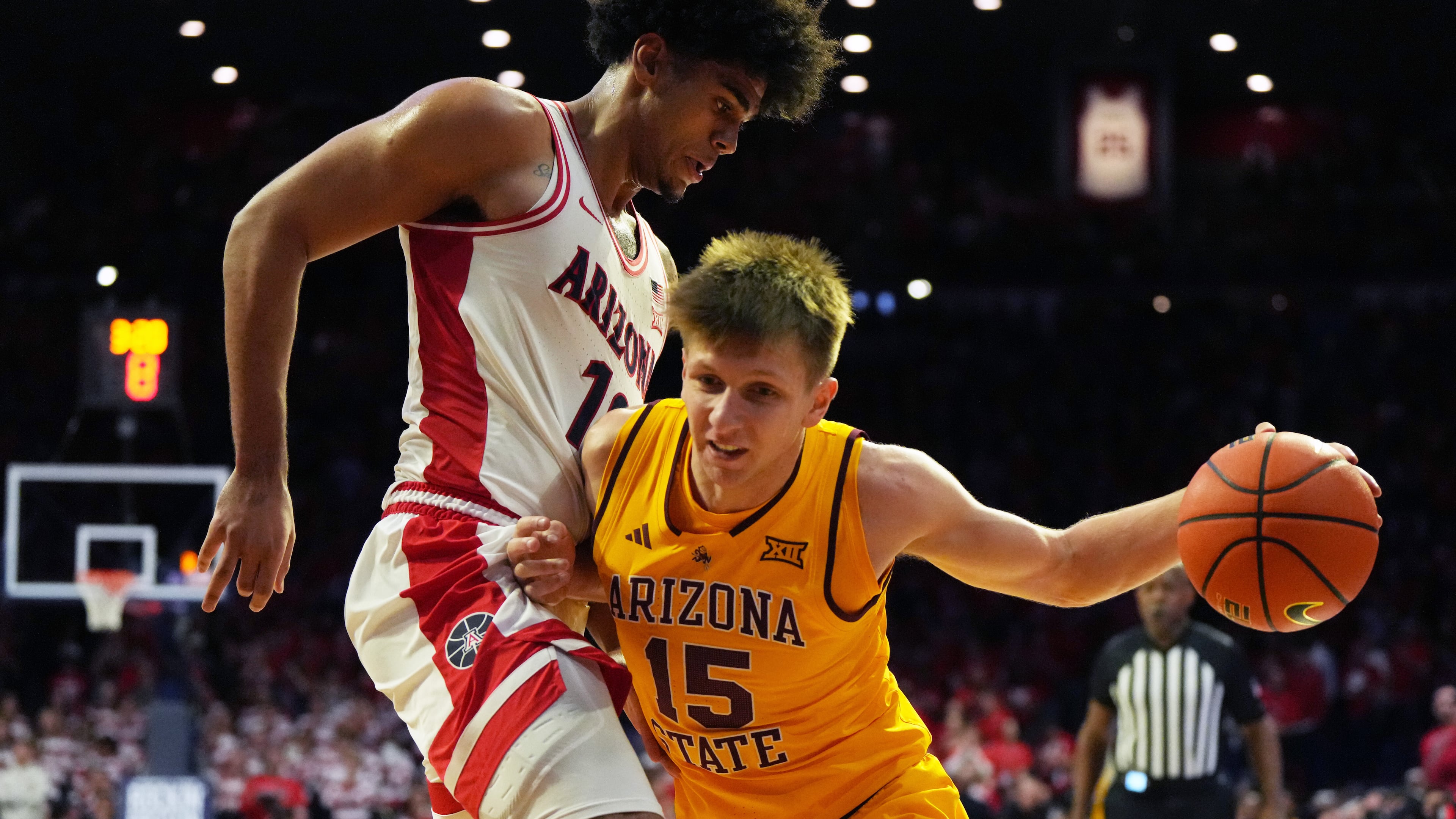 Arizona State guard Noah Meeusen (15) drives on Arizona forward Koa Peat during the first half of an NCAA college basketball game, Wednesday, Jan. 14, 2026, in Tucson, Ariz. (AP Photo/Rick Scuteri)