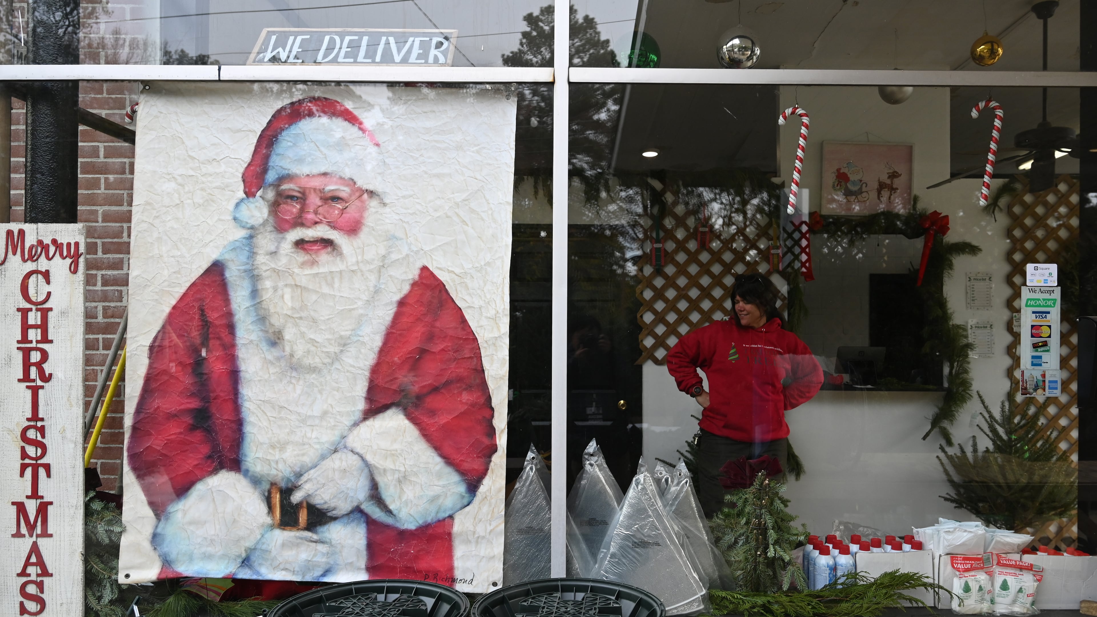 Michelle Stell smiles as she chats with other staff members Dec. 4 at Tradition Trees’ Chamblee lot in Atlanta. (Hyosub Shin/The Atlanta Journal-Constitution)