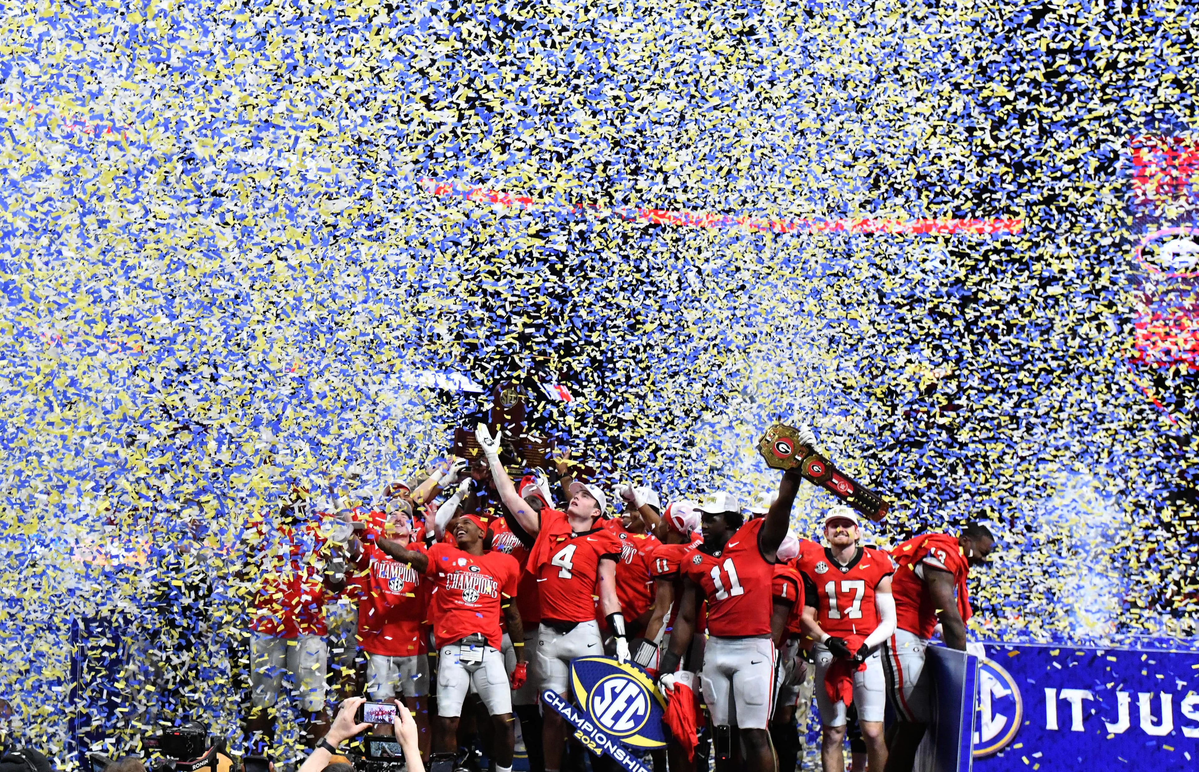 Georgia players celebrate the victory over Texas in overtime during the SEC Championship football game at the Mercedes-Benz Stadium, Saturday, December 7, 2024, in Atlanta. Georgia won 22-19 over Texas in overtime. (Hyosub Shin / AJC)