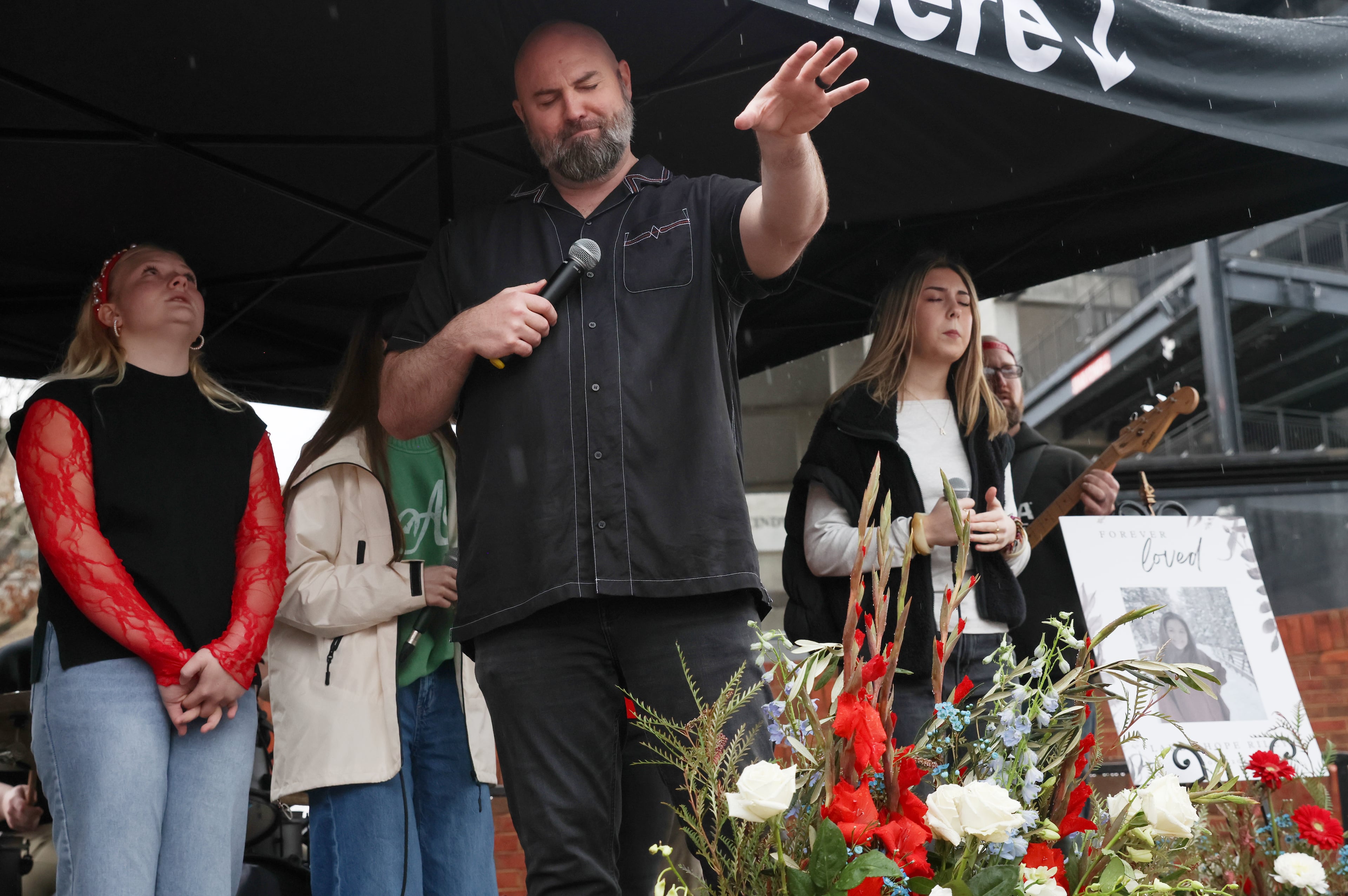 Derek Anglin, lead pastor of NewGrace Church in Commerce, presides over a worship service at UGA’s Tate Plaza on Saturday, Feb. 21, 2026, during a memorial for Augusta University nursing student Laken Riley. Riley was attacked and killed while running on the UGA campus in February 2024. Anglin’s sermon “Run for Your Life” inspired the memorial event’s title. (C.J. Bartunek for the AJC)