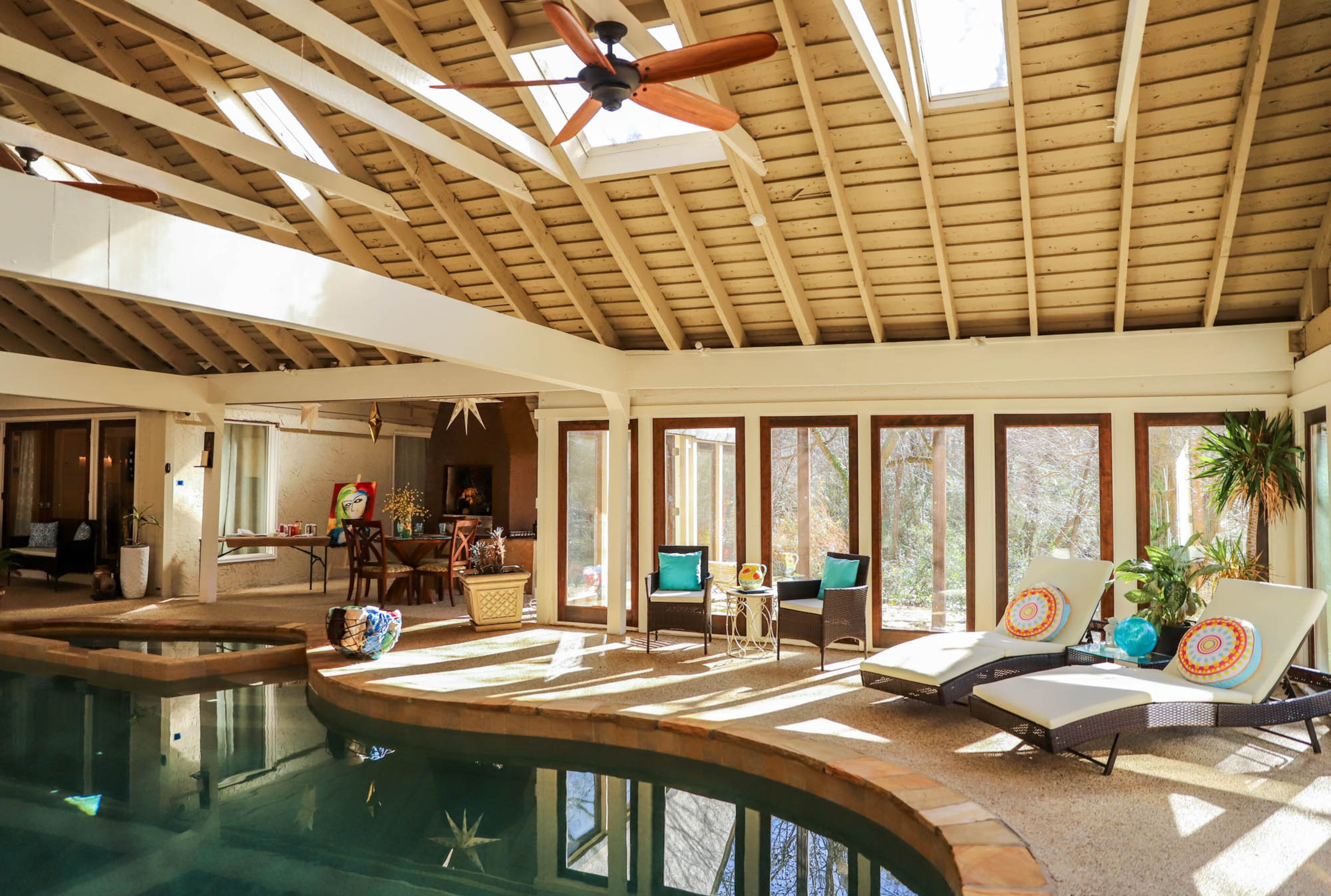 Even with the doors closed, two fans added to the soaring ceilings provide cool breezes in the room, which receives plenty of natural light from the skylights and walls of windows.