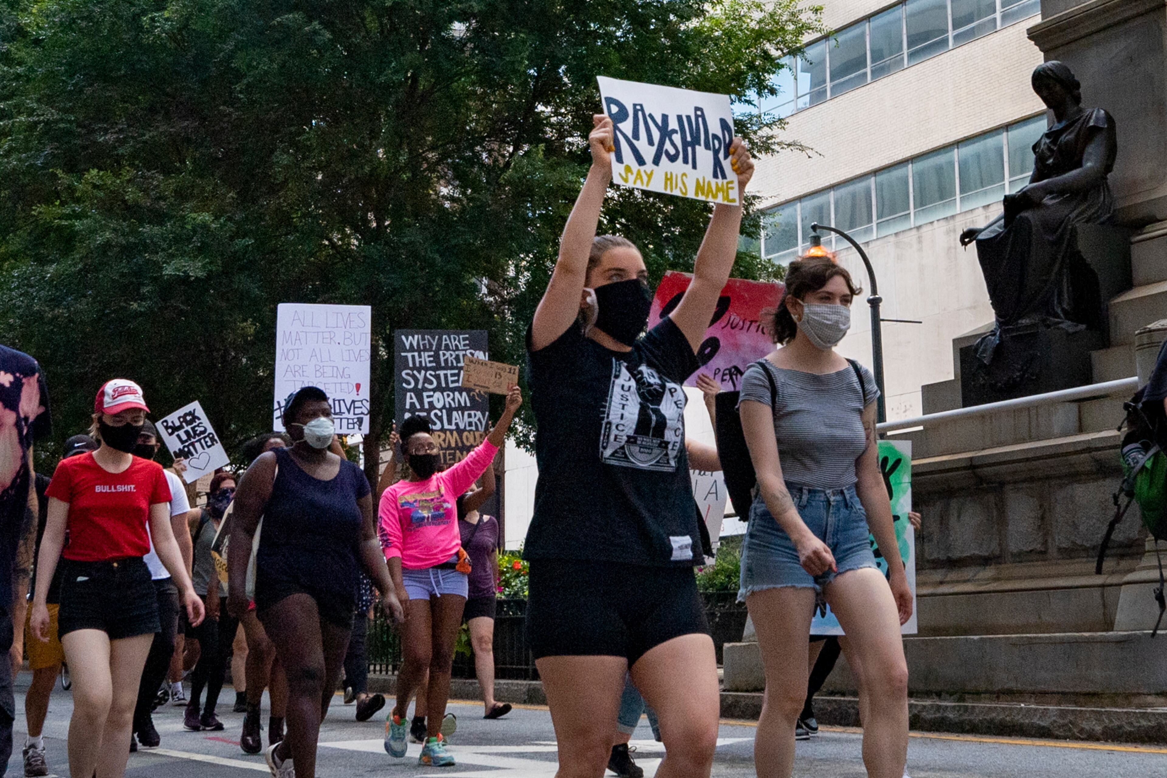 A group of protesters walk down Marietta Street on Saturday, June 13, 2020, past a statue of Henry Grady during a protest over the police shootings, including Rayshard Brooks, a 27-year-old black man, who was shot and killed by Atlanta Police on Friday evening during a struggle in a drive-thru line. JOHN AMIS FOR THE ATLANTA JOURNAL-CONSTITUTION.