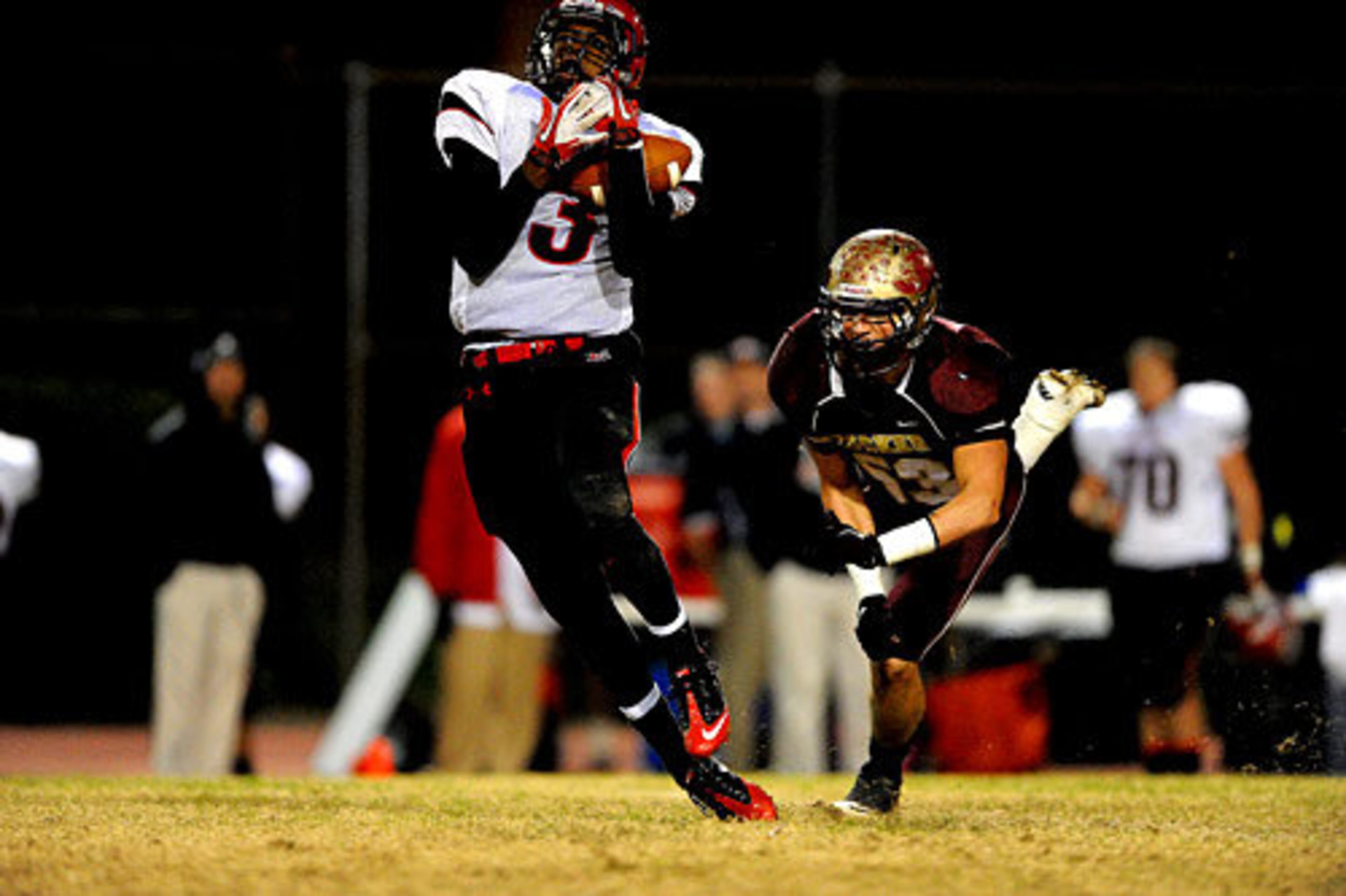 Flowery Branch's Casey Osborne (3) catches a tipped ball as Tucker's Jacob Sealand (53) tries to close the gap.
