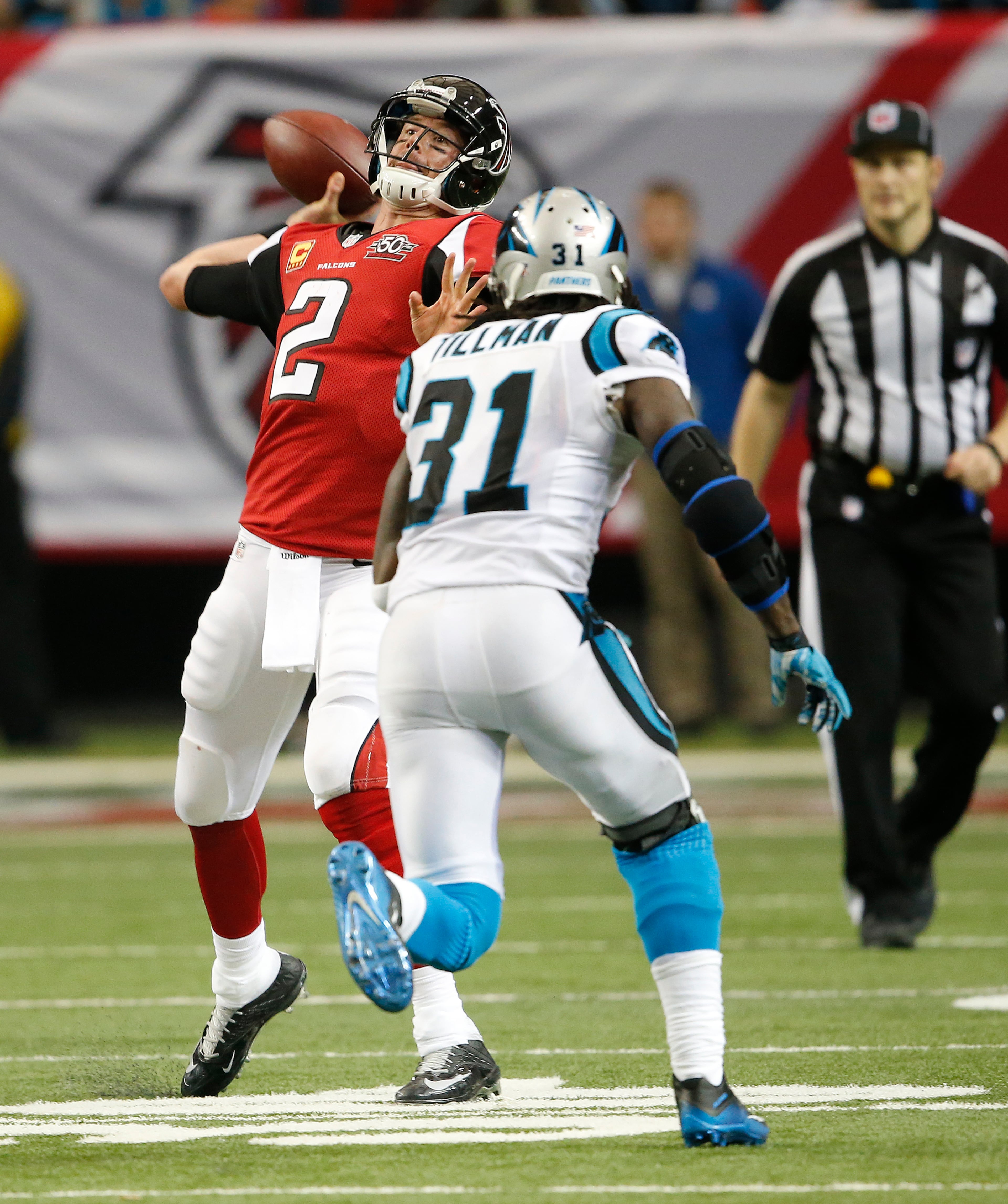 Atlanta Falcons quarterback Matt Ryan (2) passes the ball to Atlanta Falcons wide receiver Julio Jones (11) as Carolina Panthers cornerback Charles Tillman (31) defends during the second half of an NFL football game, Sunday, Dec. 27, 2015, in Atlanta. (AP Photo/John Bazemore)