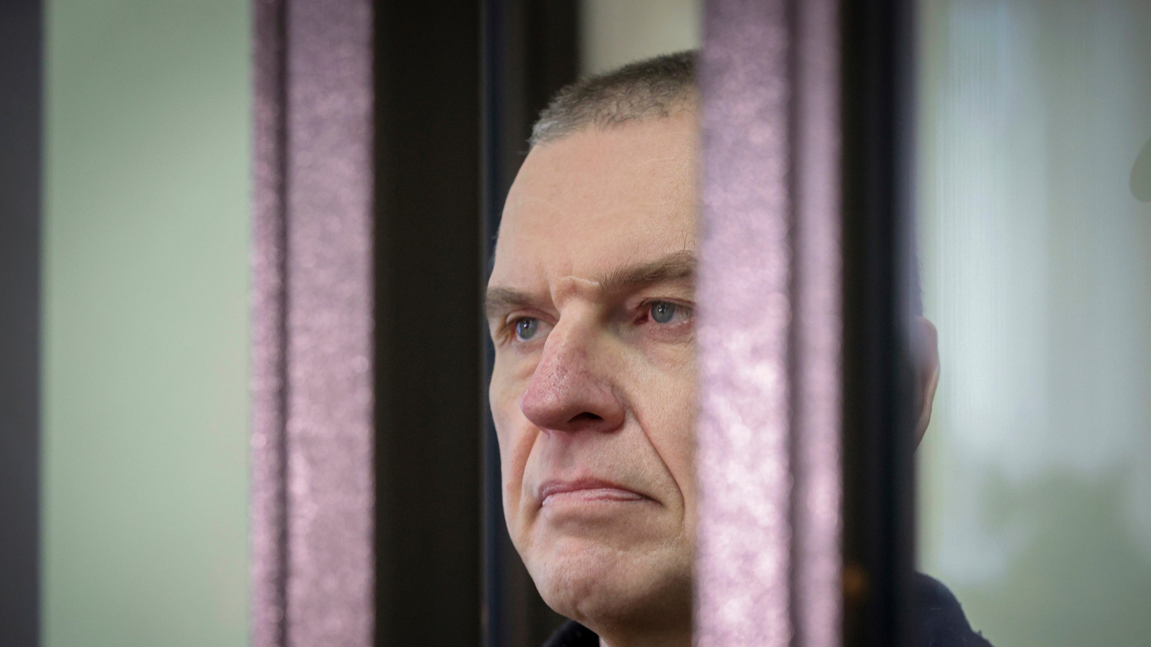 FILE - Journalist Andrzej Poczobut stands in a defendants' cage in court in Grodno, Belarus, on Jan. 16, 2023. (Leonid Shcheglov/Pool via AP, File)