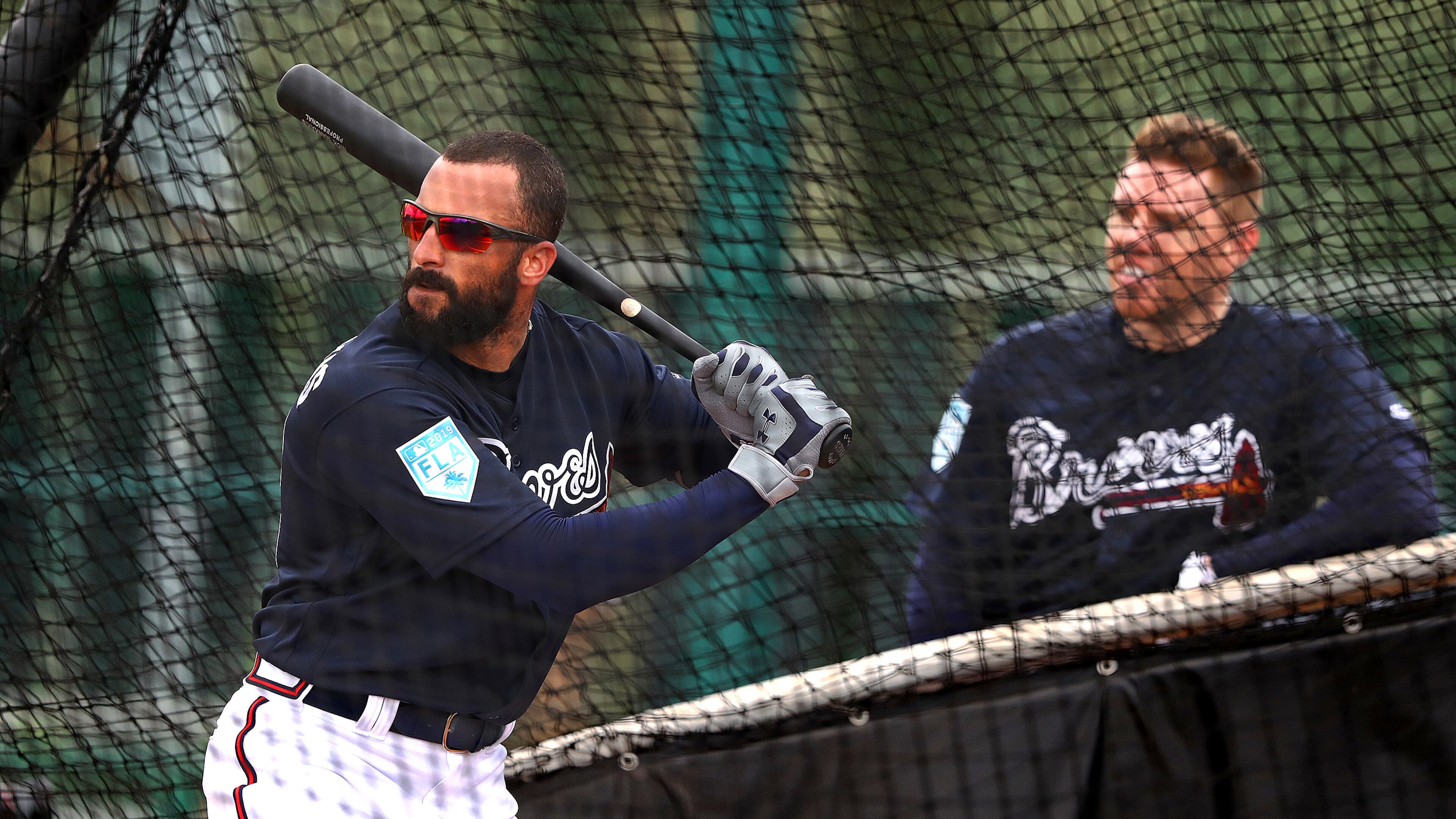 Atlanta Braves outfielder Nick Markakis takes batting practice while Freddie Freeman (background) waits on deck during the first full squad workout at spring training Thursday, Feb. 21, 2019, in the ESPN Wide World of Sports Complex in Lake Buena Vista, Fla.