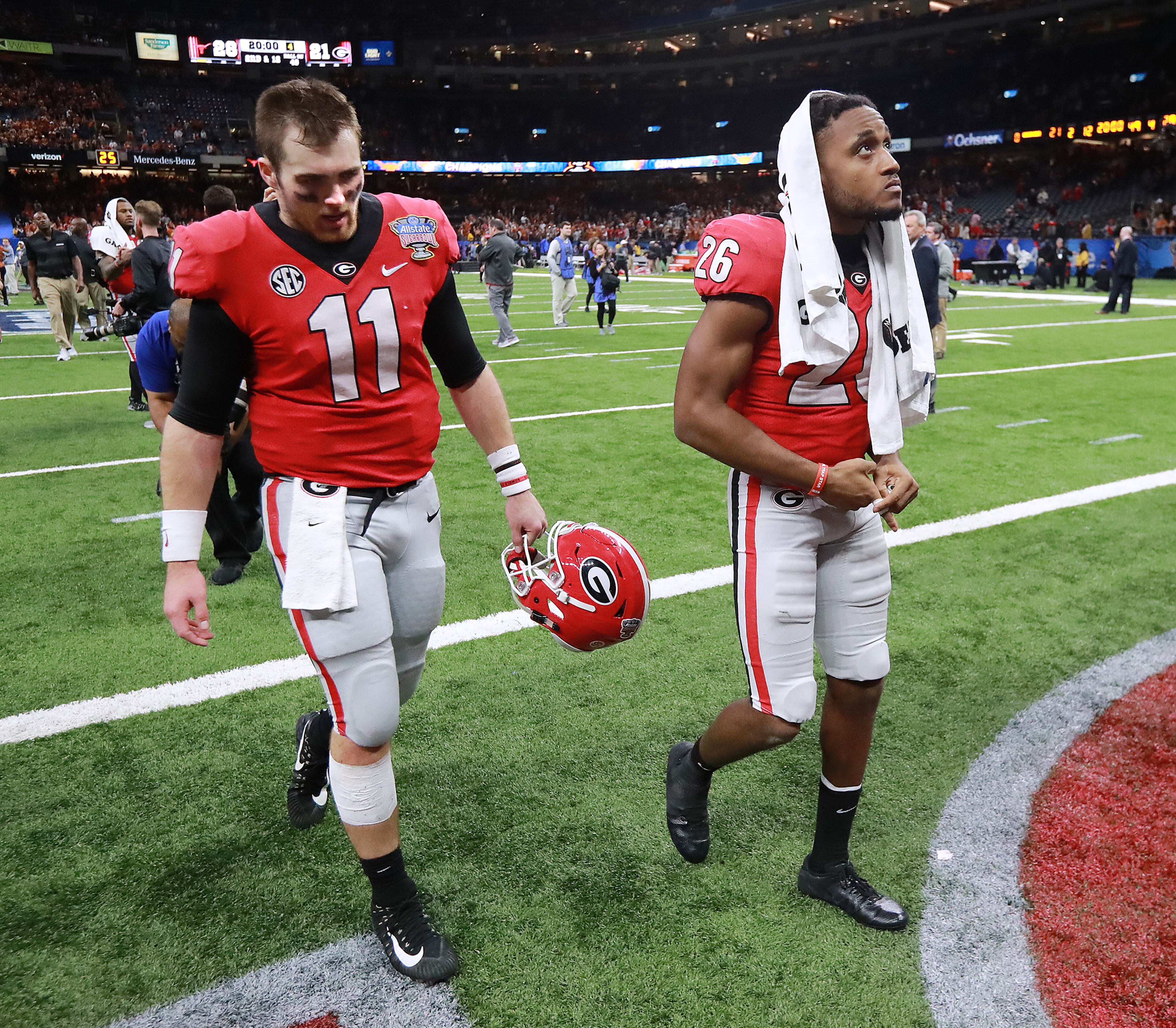Jan. 01, 2019 New Orleans: Georgia quarterback Jake Fromm and defensive back Tyrique McGhee walk off the field dejected falling 28-21 to Texas in the Allstate Sugar Bowl at Mercedes-Benz Superdome on Tuesday, Jan. 1, 2019, in New Orleans. Curtis Compton/ccompton@ajc.com