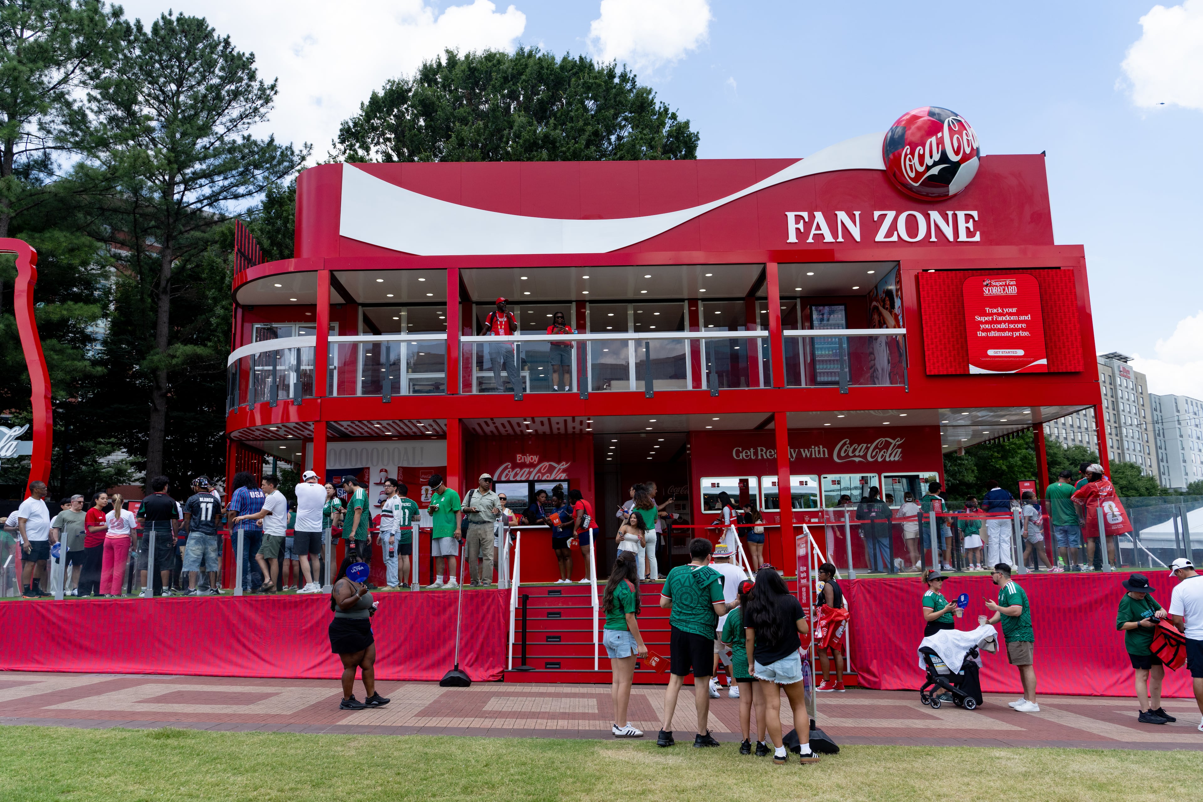People line up to enter the Coca-Cola Fan Zone booth on opening day of the FIFA Fan Festival at Centennial Olympic Park on Thursday, June 11, 2026. (Ben Hendren for the AJC)