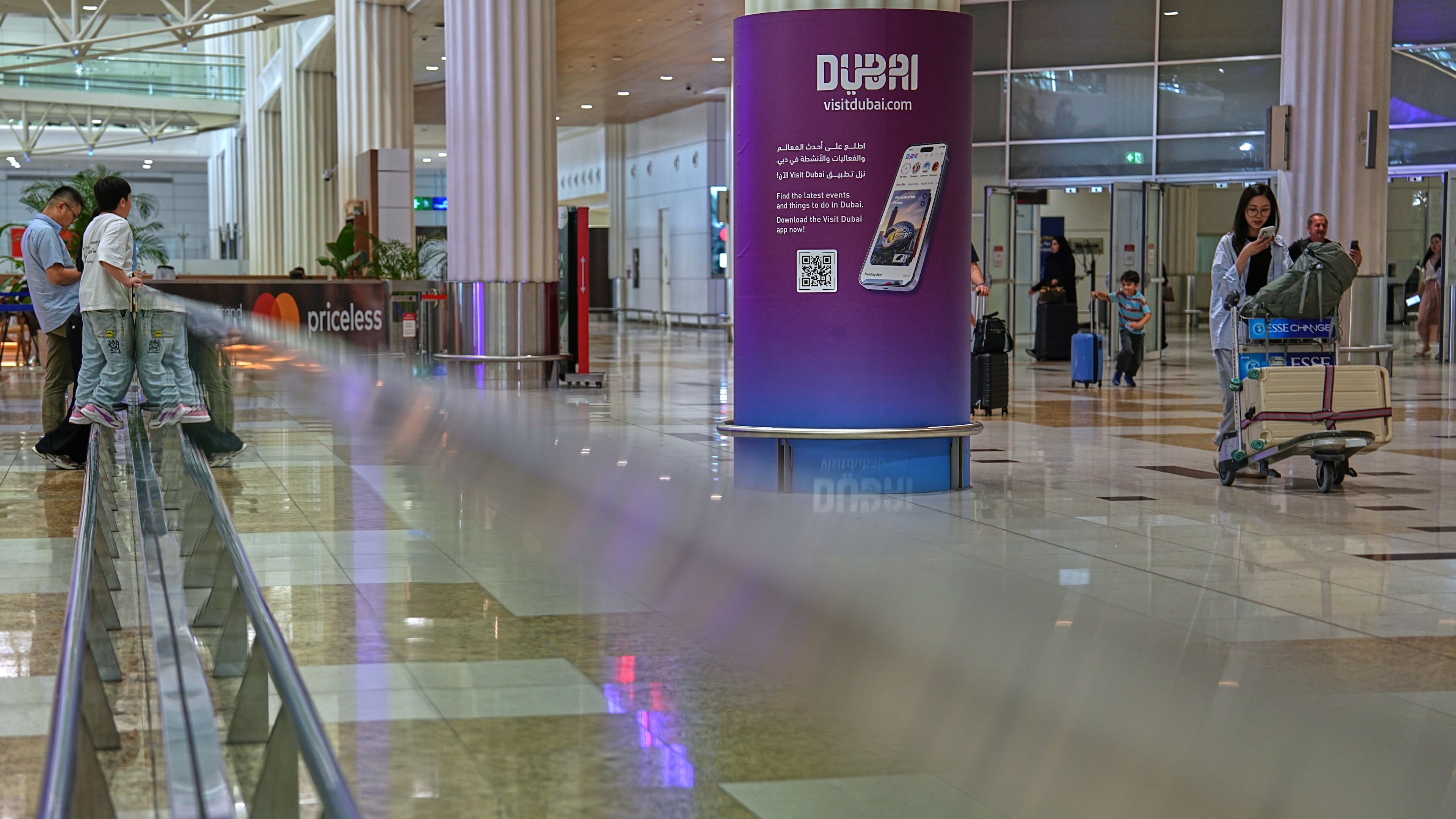 Passengers leave the baggage claim hall at Terminal 3 of Dubai International Airport in Dubai, United Arab Emirates, Wednesday, Aug. 26, 2026. (AP Photo/ Fatima Shbair)