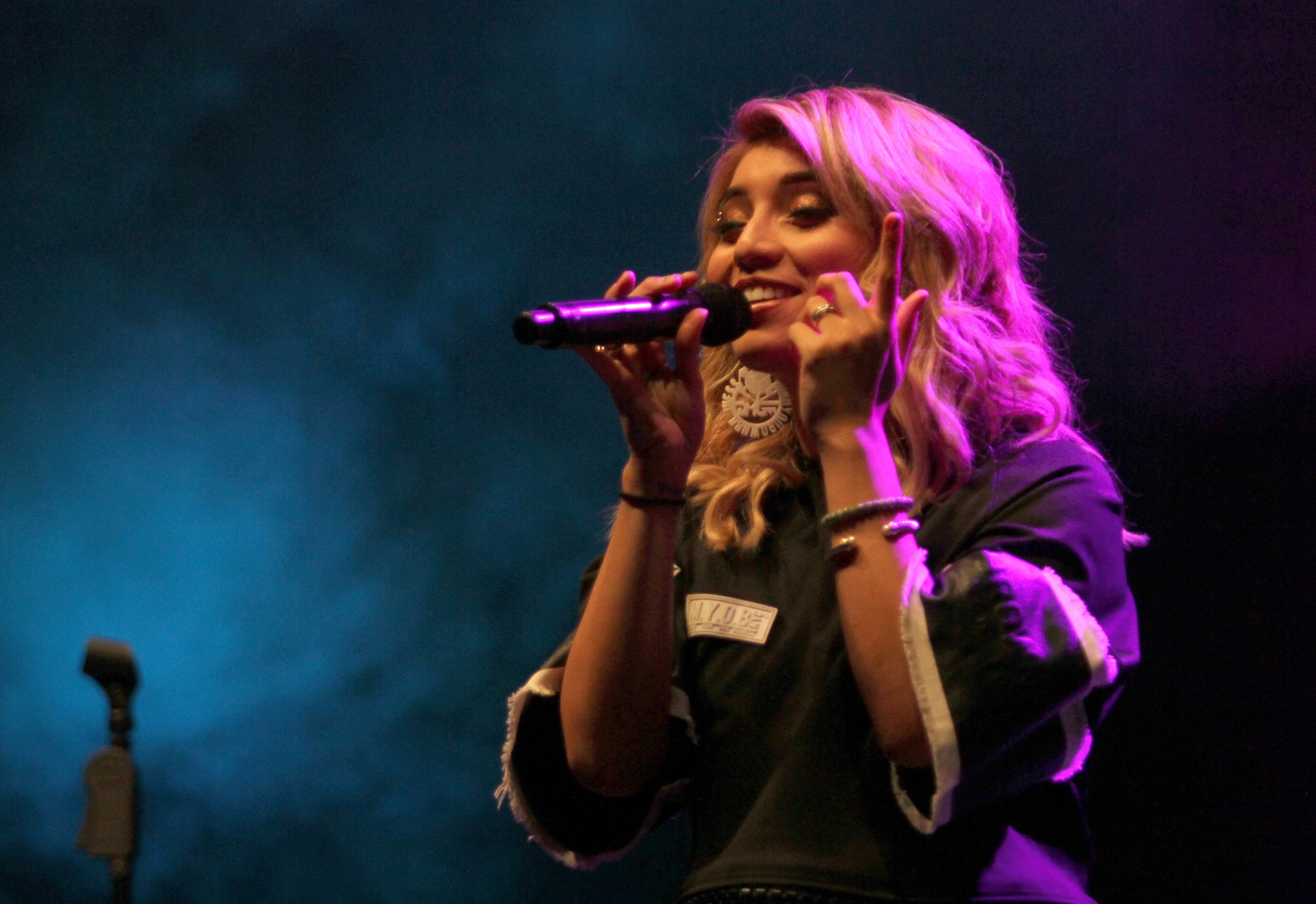 Kirstin Maldonado, founding member of a cappella group Pentatonix, performing at the Star94 Jingle Jam at the Fox Theatre on Monday. (Akili-Casundria Ramsess/Special to the AJC)
