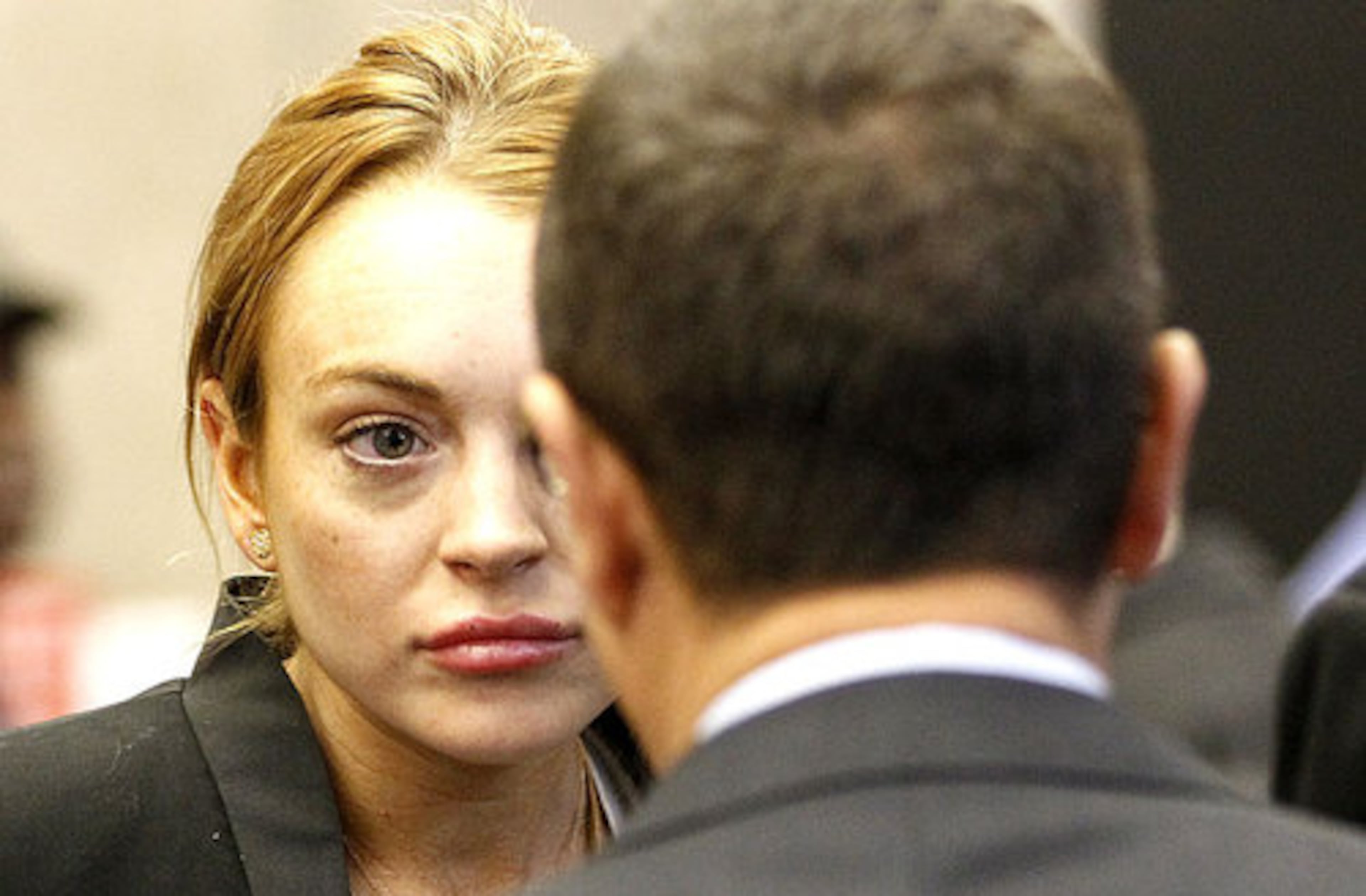 Lindsay Lohan looks at a court official as she arrives in court. Judge Fox told the actress that he would not be manipulated by her, but was giving her a final chance to stay clean.