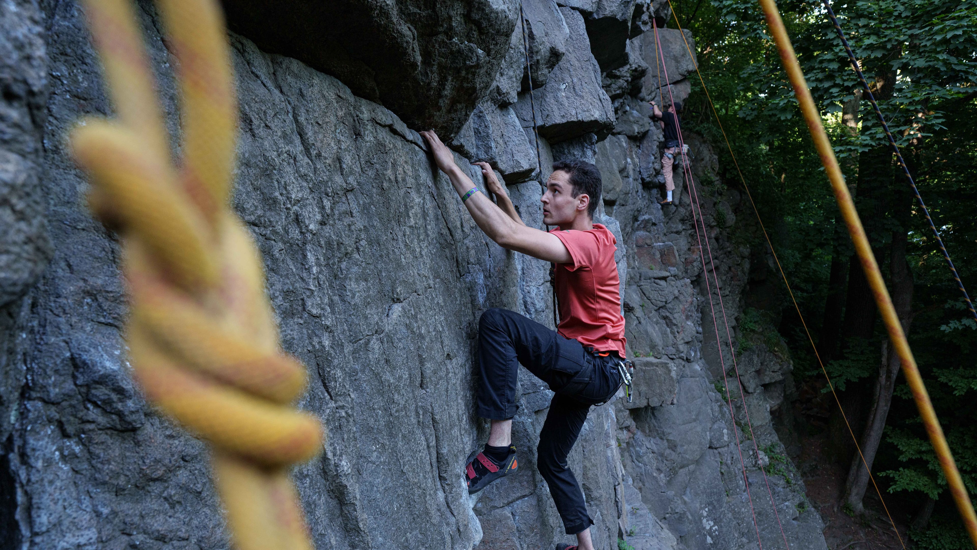 A man climbs on a cliff during the Stoned Climbers festival near Denyshi, Zhytomyr region, Ukraine, Saturday, June 27, 2026. (AP Photo/Evgeniy Maloletka)