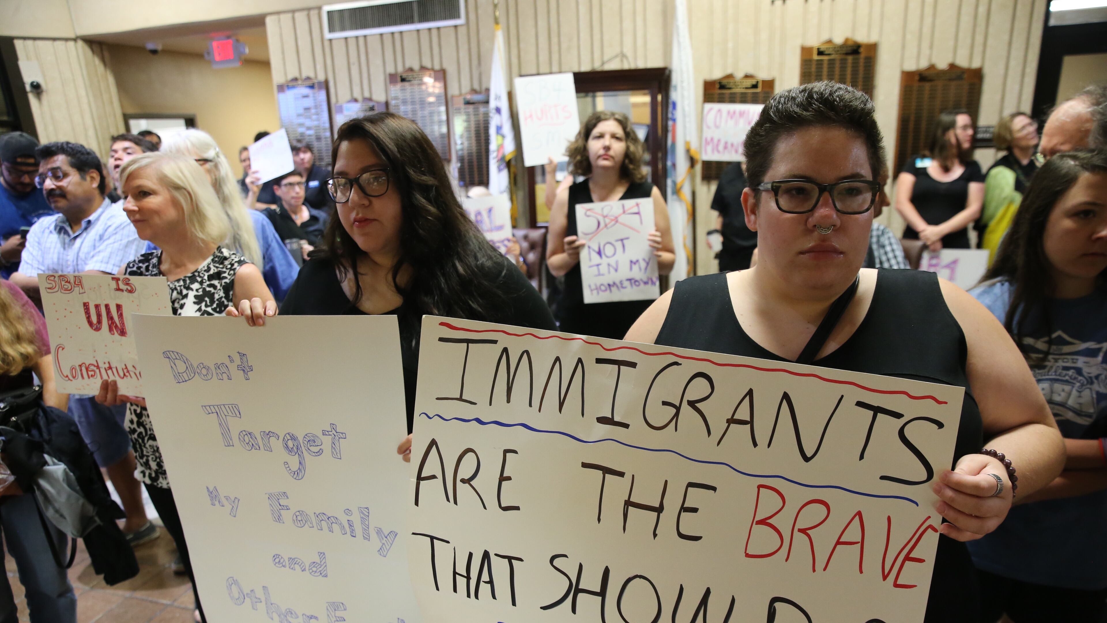 San Marcos city council voted unanimously to file an amicus brief against SB 4 siding with their diverse community to protect immigrant rights during an early morning session Tuesday August 22, 2017. Mayor John Thomaides, left and Councilwoman Lisa Prewitt, right, both gave impassioned speeches before the vote.