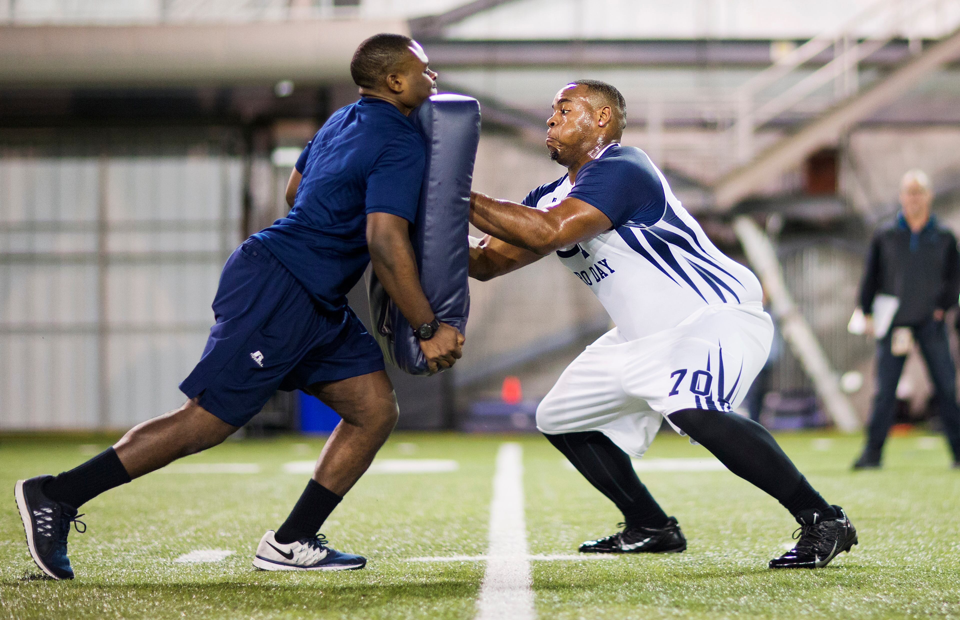 Shaquille Mason, right, runs a football drill with strength conditioning intern Tevone Allen during NFL Pro Day at Georgia Tech Friday, March 13, 2015, in Atlanta. (AP Photo/David Goldman)