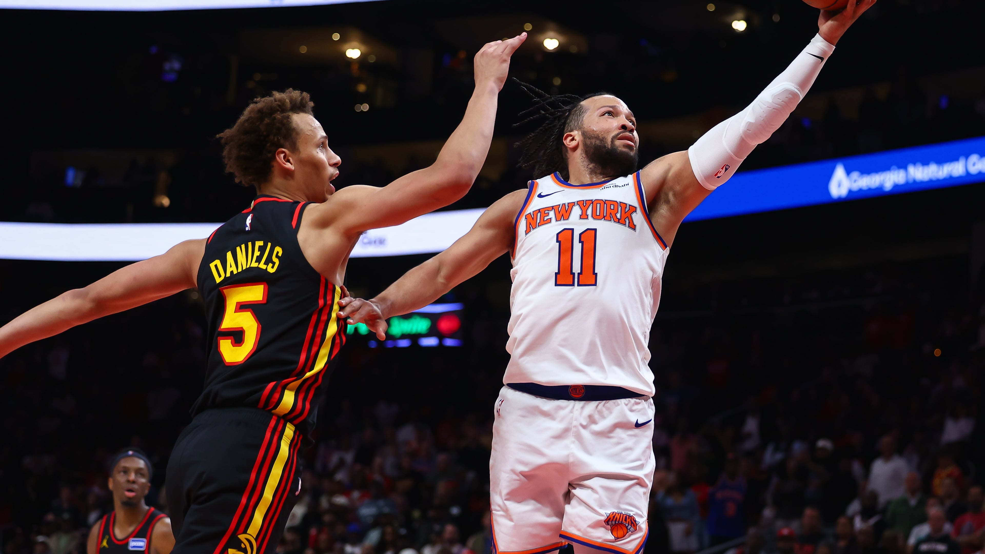 New York Knicks guard Jalen Brunson (11) shoots against Atlanta Hawks guard Dyson Daniels (5) during the second half of an NBA basketball game, Monday, April 6, 2026, in Atlanta. (AP Photo/Colin Hubbard)